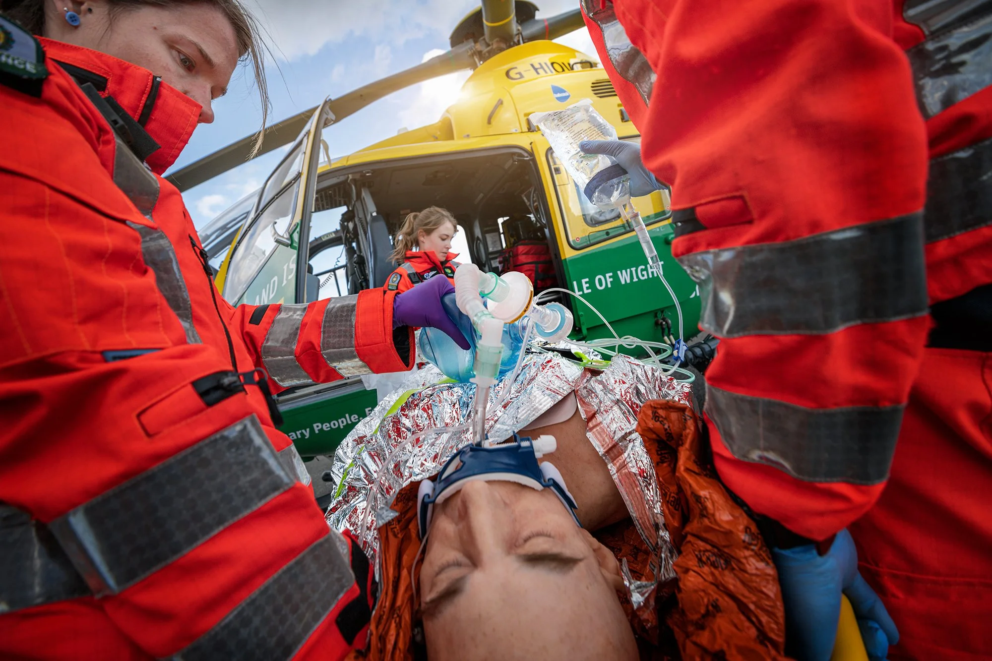Air Ambulance crew carrying a man into helicopter.