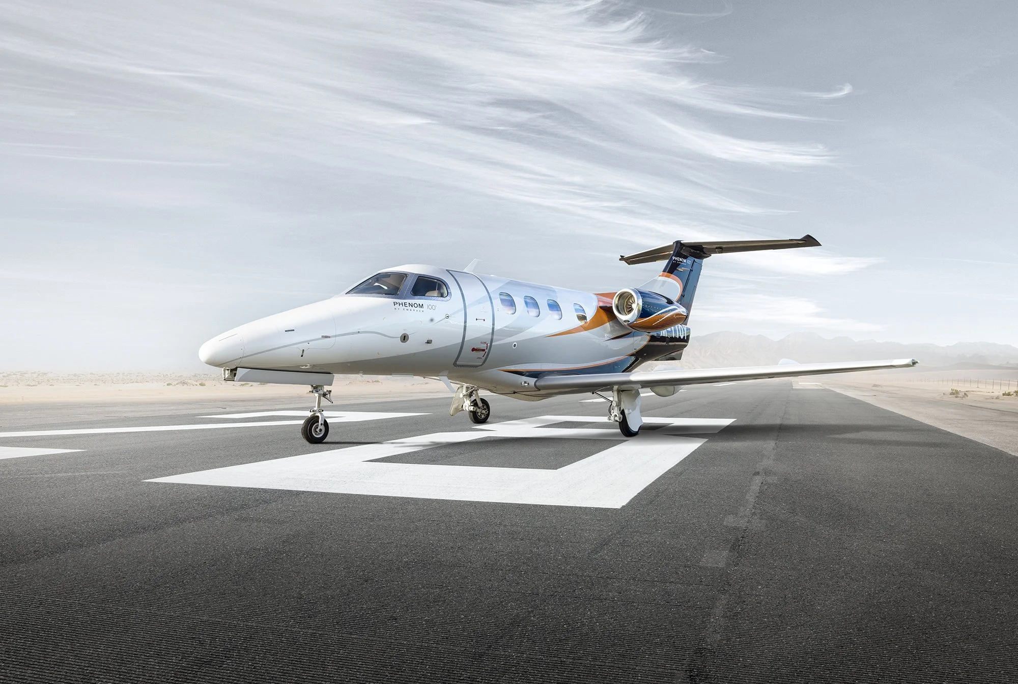 Phenom private jet sat on runway, aviation photography