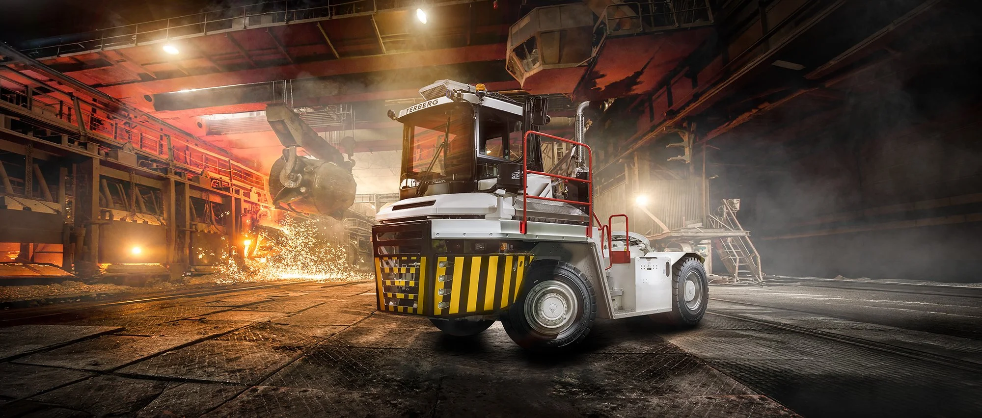 White tractor truck inside steel works with fire and sparks behind, Truck photography, Tim Wallace.