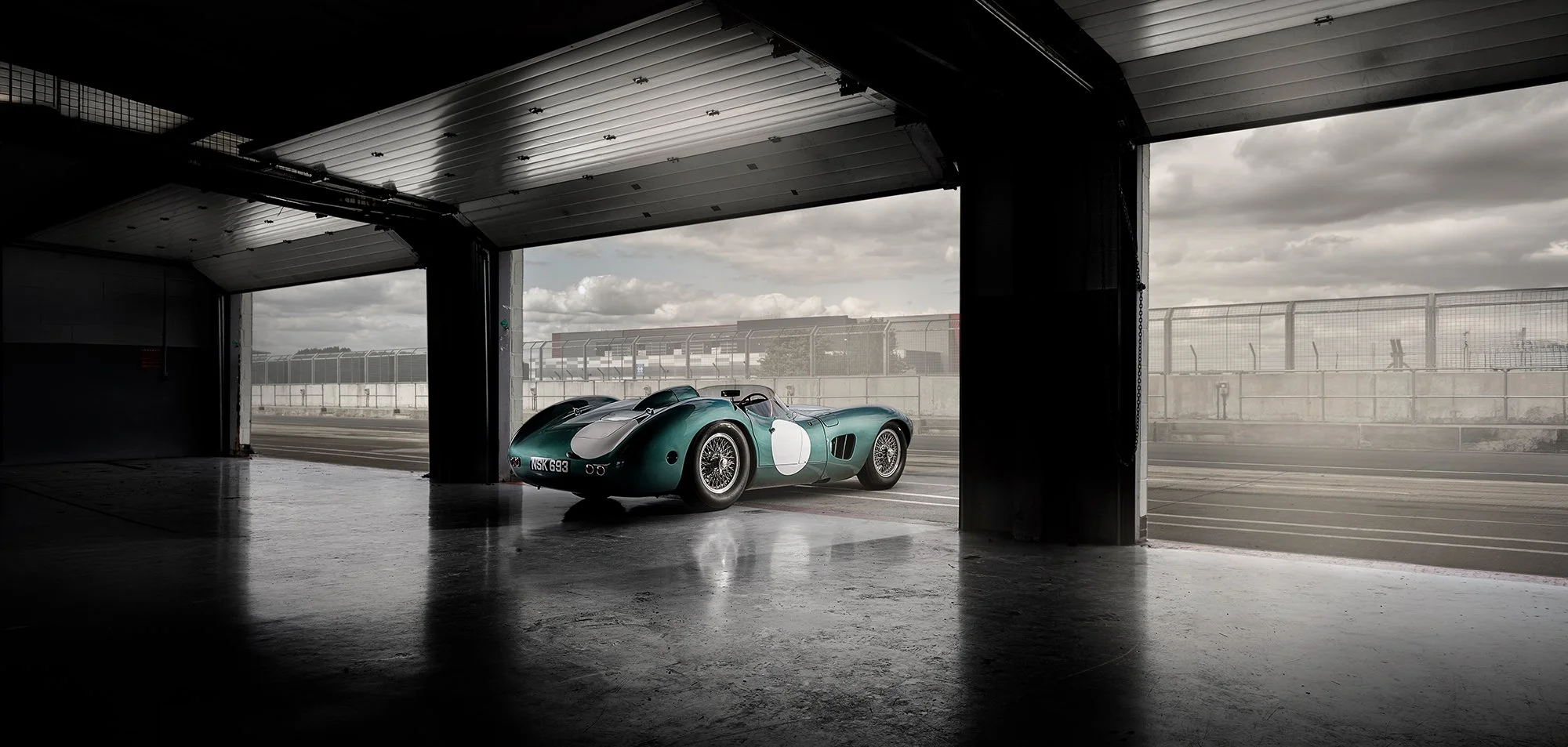 Classic Aston Martin Race Car in pit lane at Silverstone.