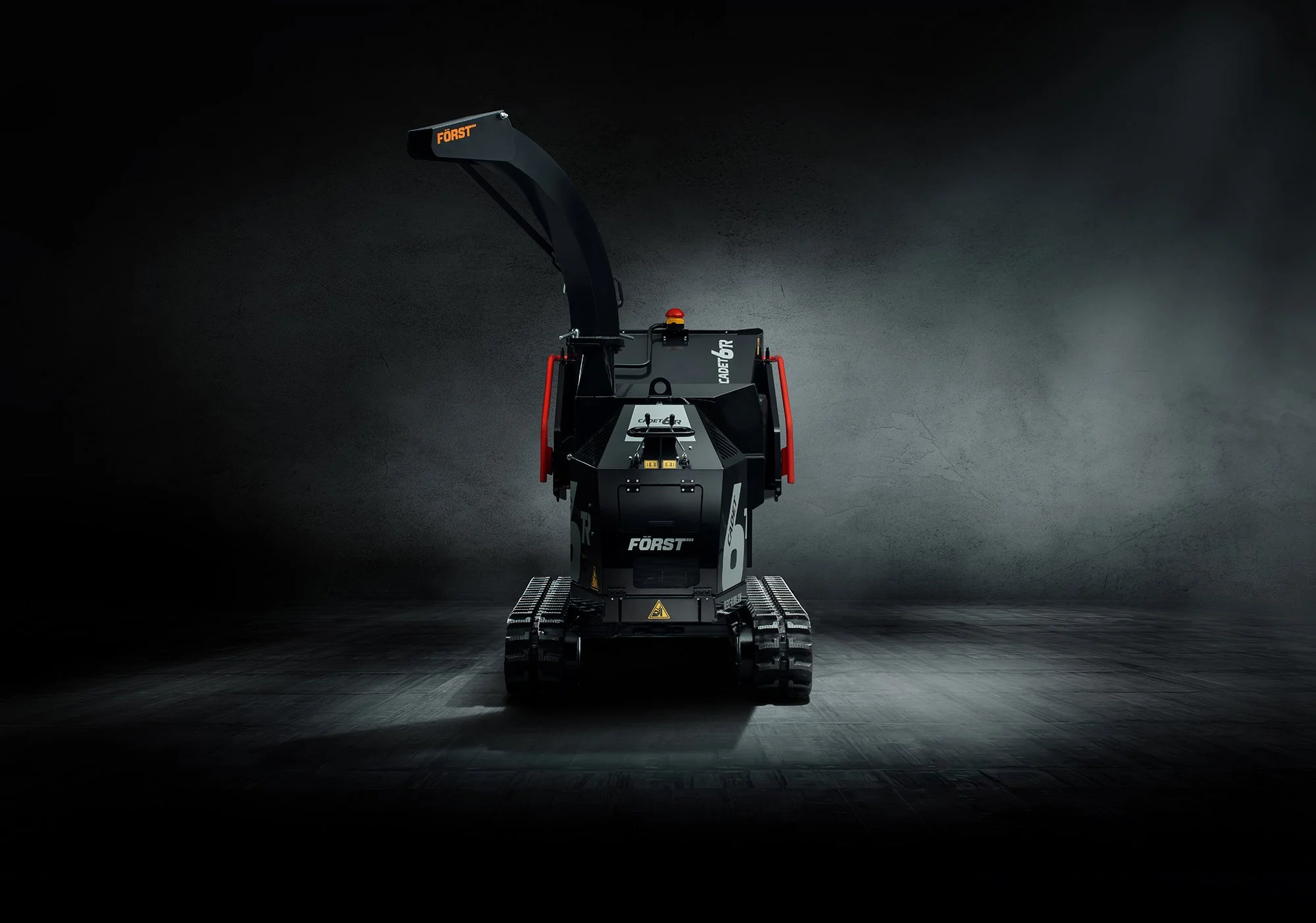 Dramatic photograph of a black Forst Wood Chipper in studio by Tim Wallace.
