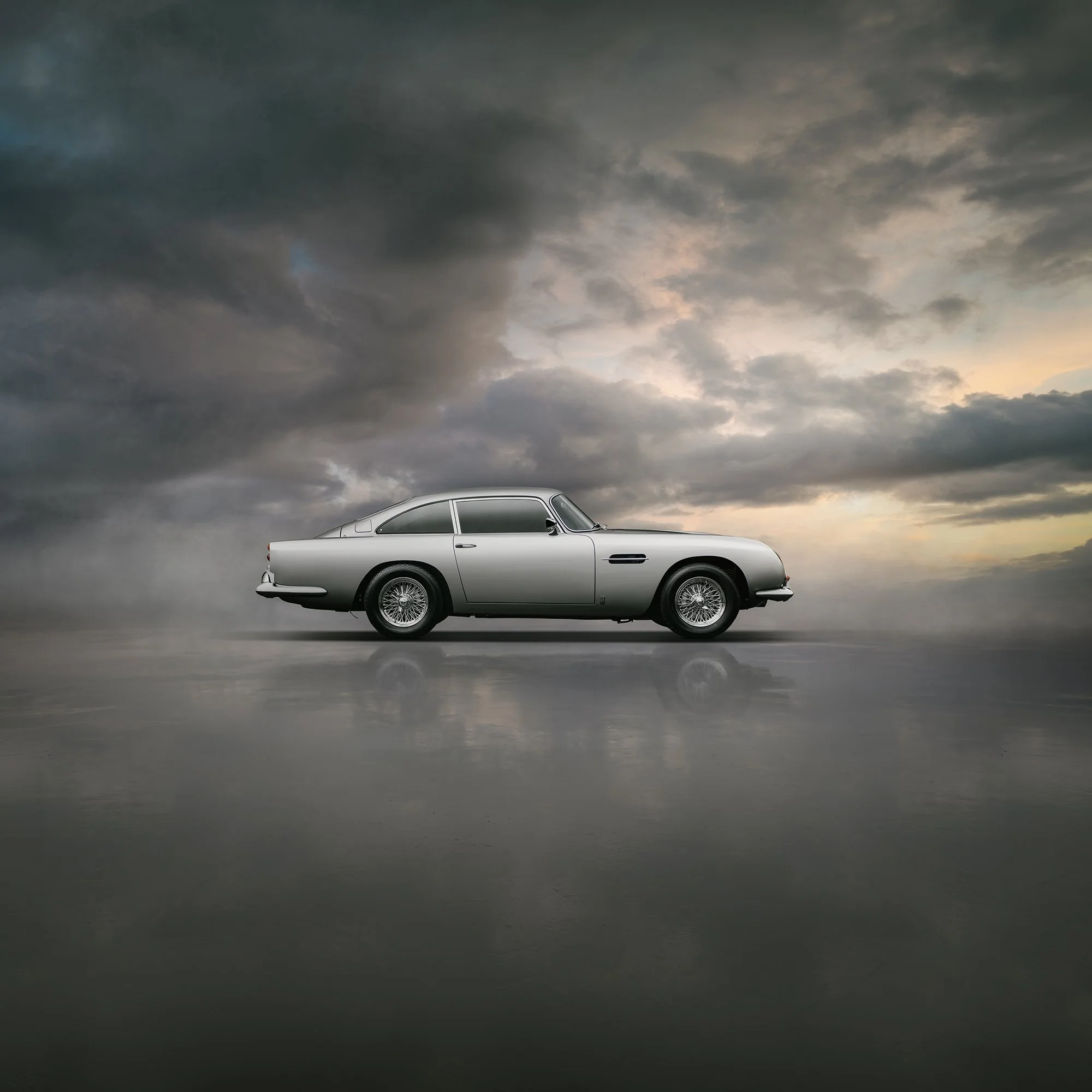Aston Martin DB5 side profile with setting sun in backgorund. 