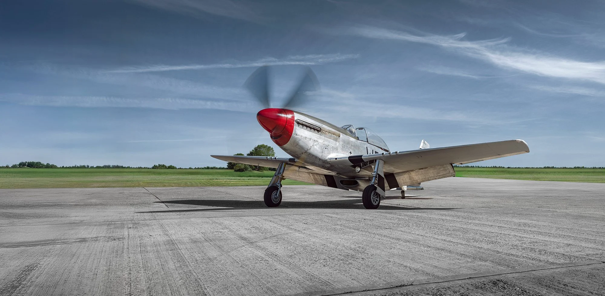 P51 Mustang with propellors moving as prepares to take off.