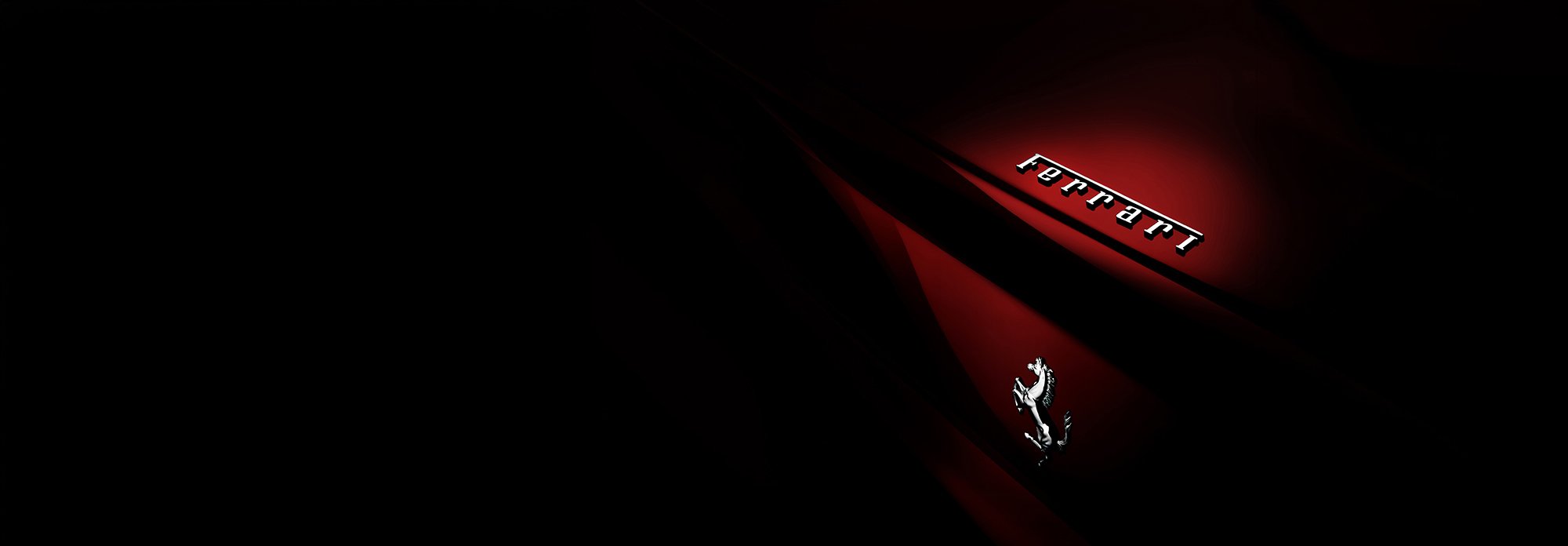 Ferrari badge lit out of the darkness, car photography.