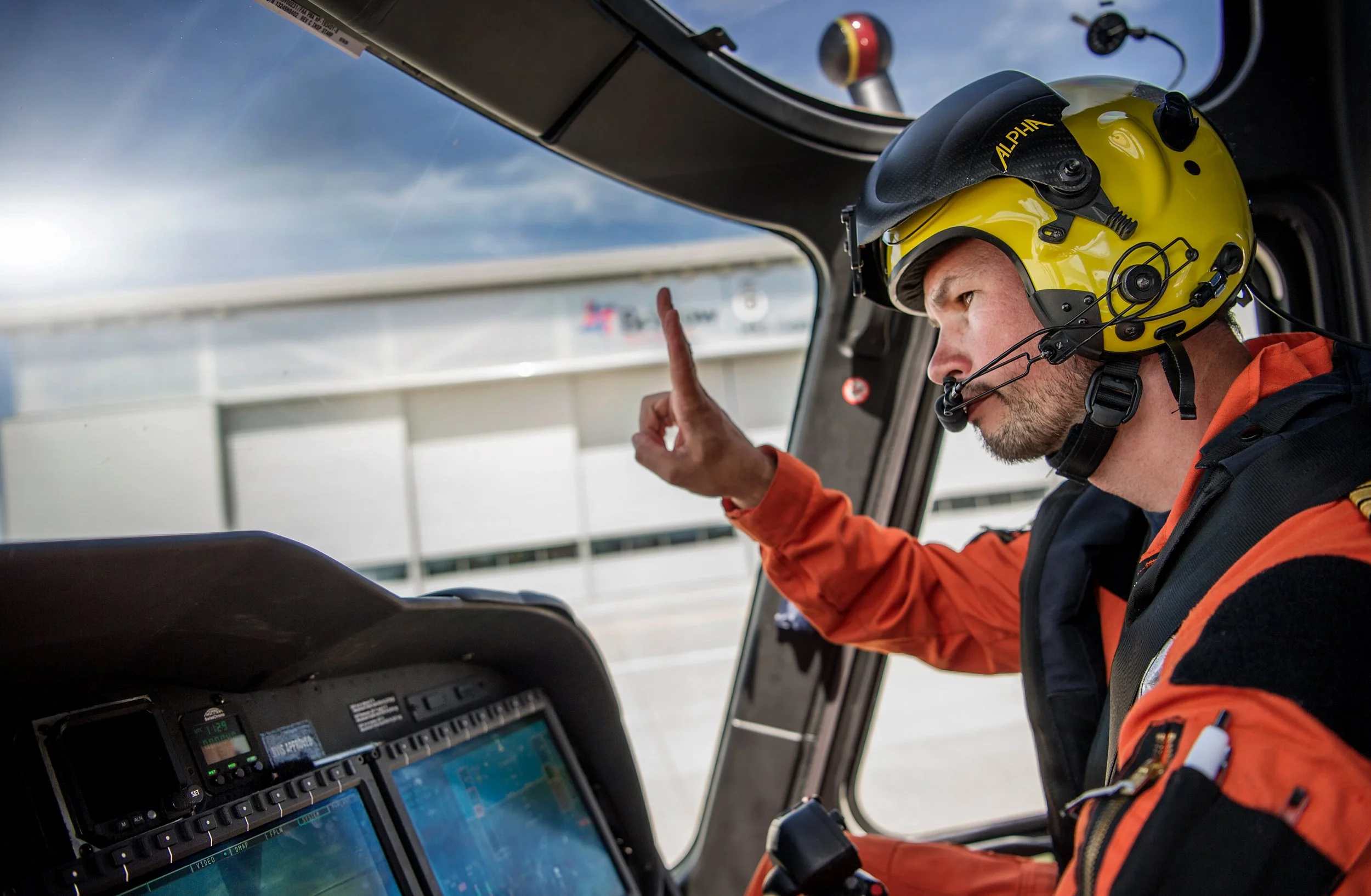 HM Coastguard Search and Rescue pilot in cockpit of helicopter preparing for take off.