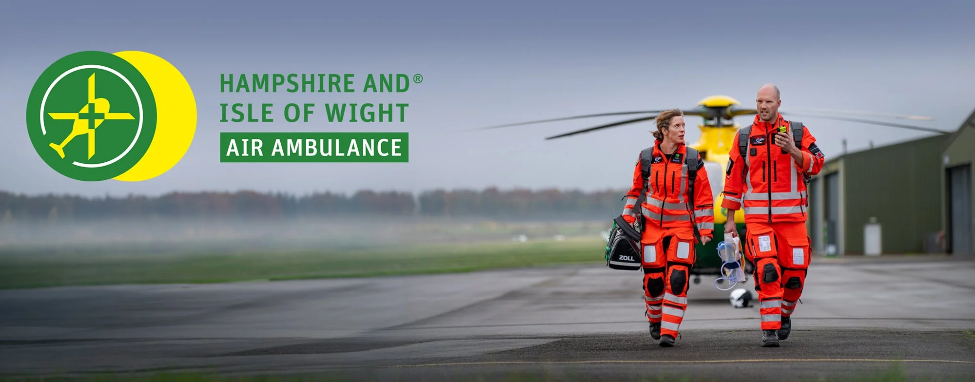Air Ambulance crew walking in front of helicopter.