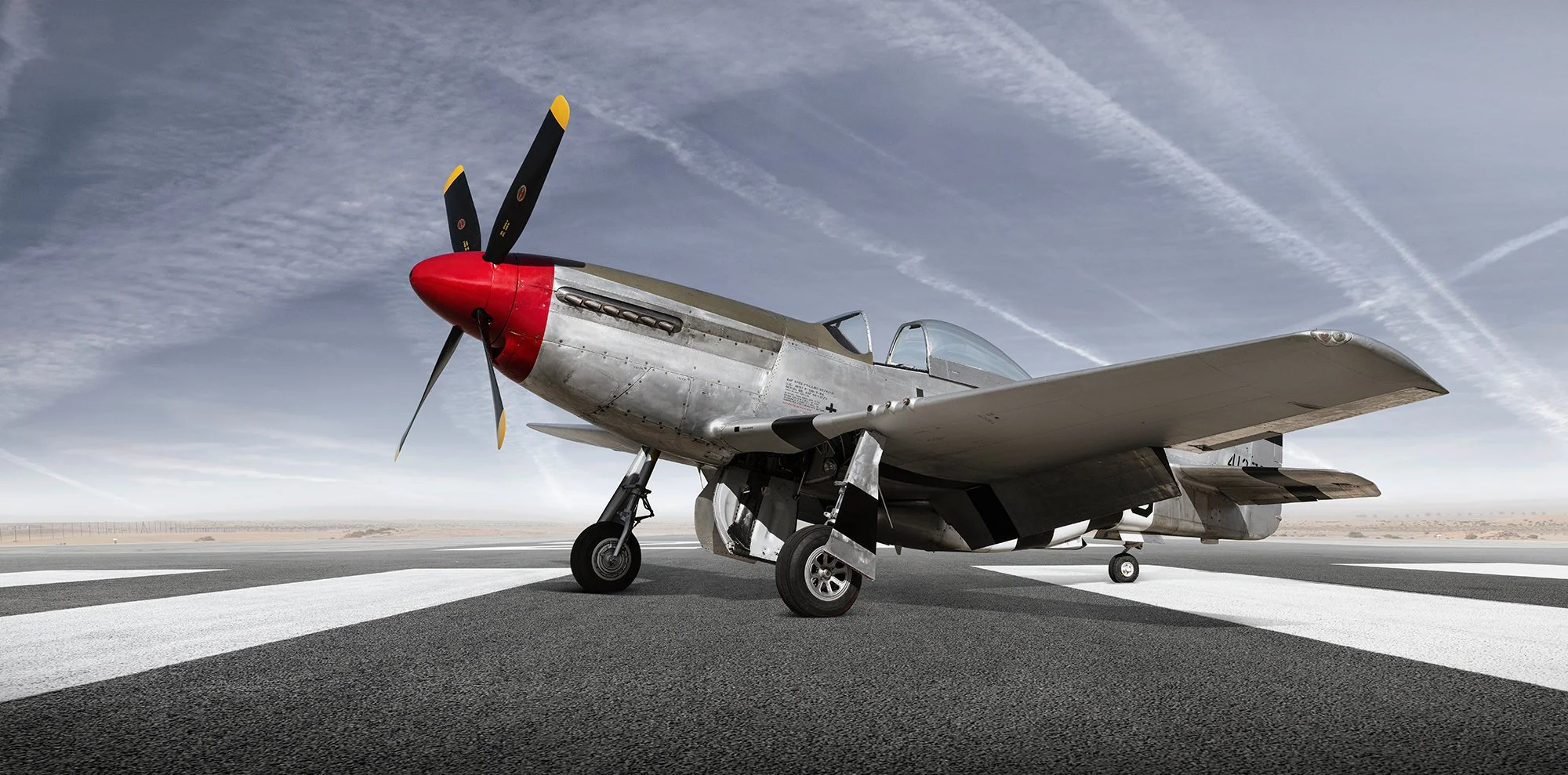 P51 Mustang aircraft, front view showing red noise cone, Aviation photographer, Tim Wallace.
