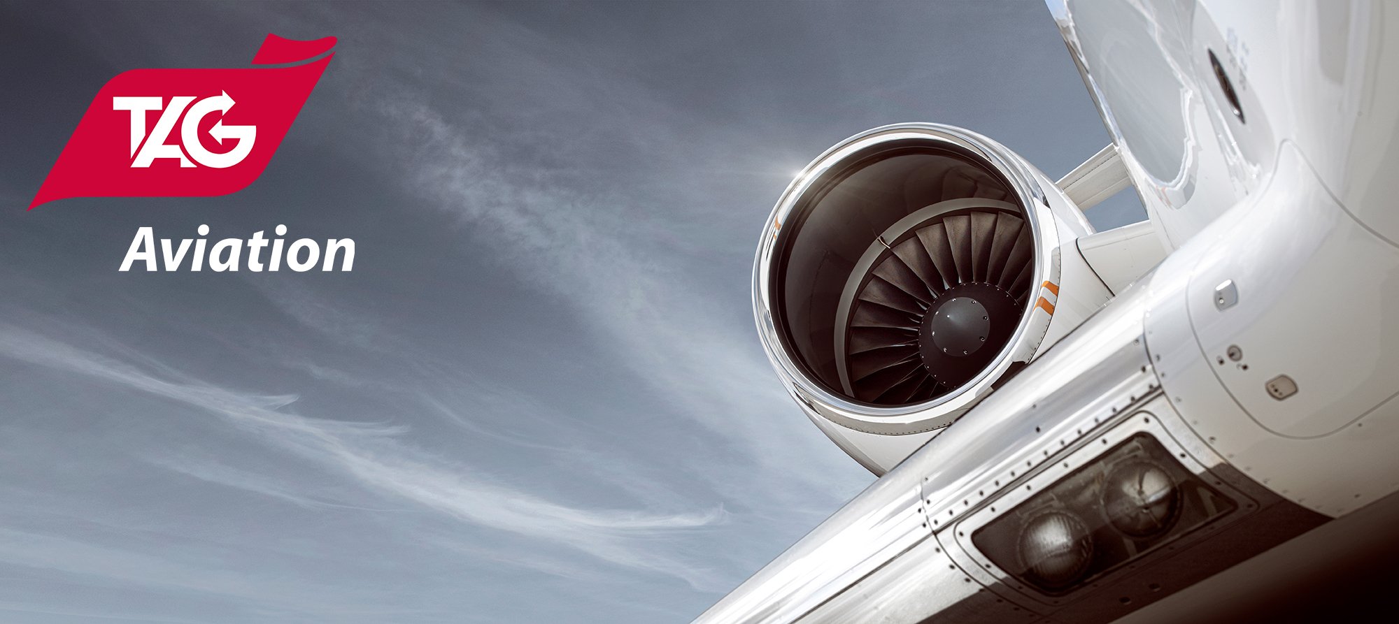 Private jet aircraft close up of engine and wing with TAG aviation logo.