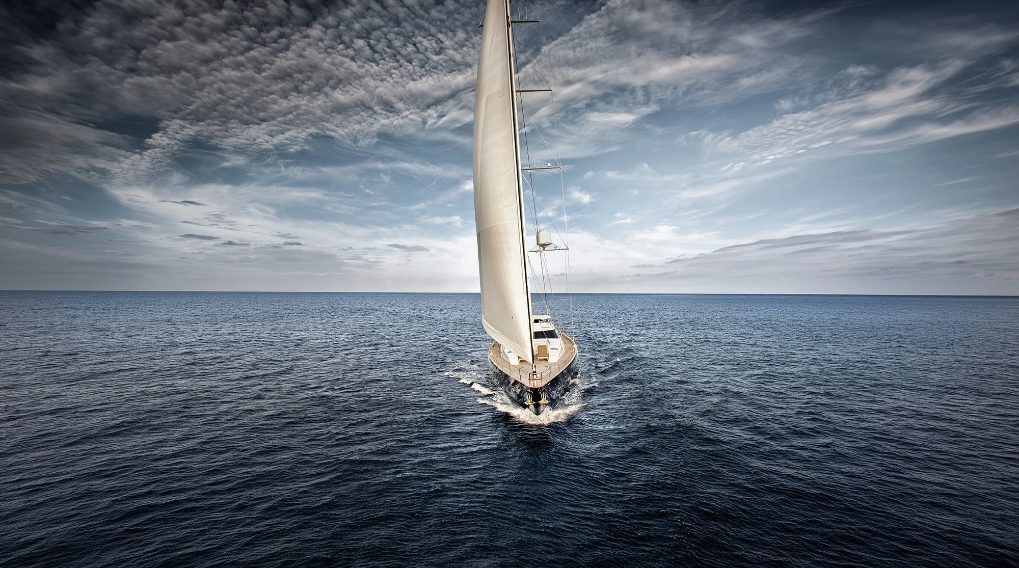 Luxury super yacht sailing across open water  