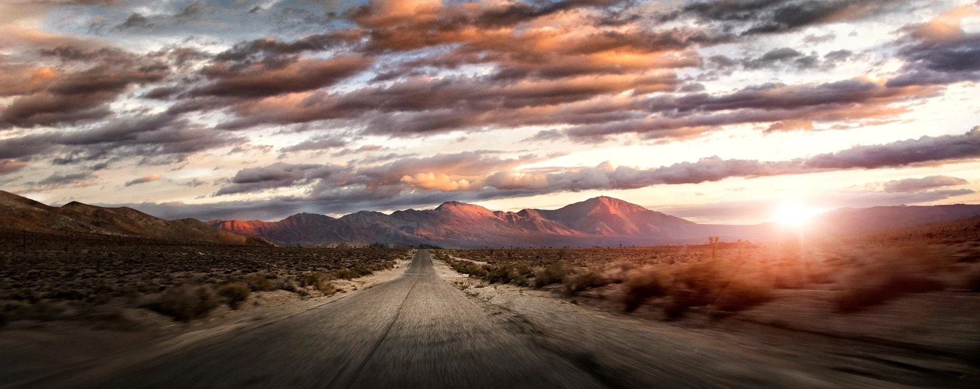 Desert road at sunset