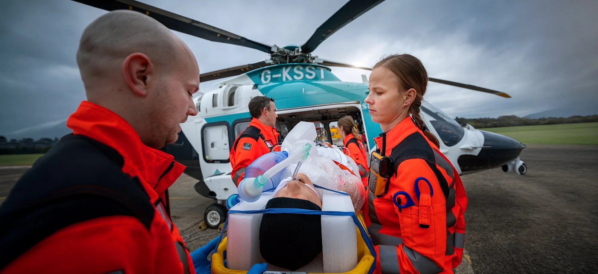 Kent Air Ambulance paramedics load casualty into helicopter 