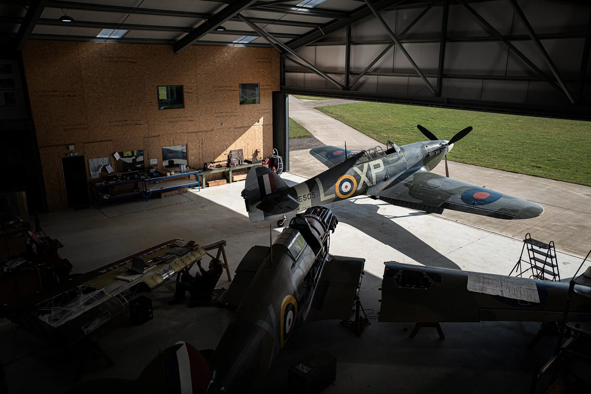 Hurricane Warbird aircraft on hanger doorway