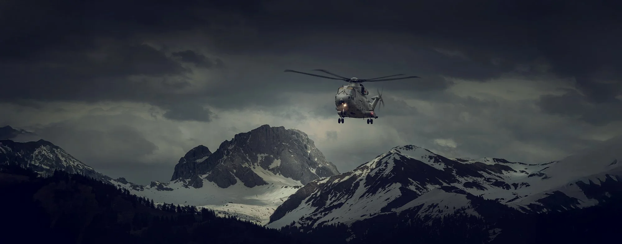 Merlin HC 4 Helicopter flying over mountains.