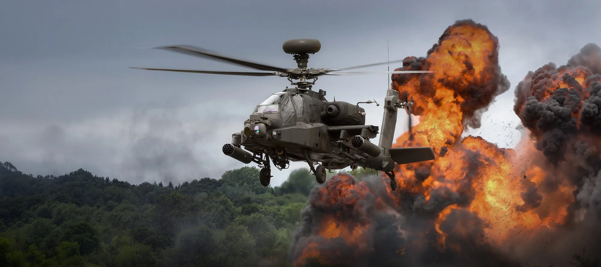 Attack helicopter flying with explosion and flames behind it 
