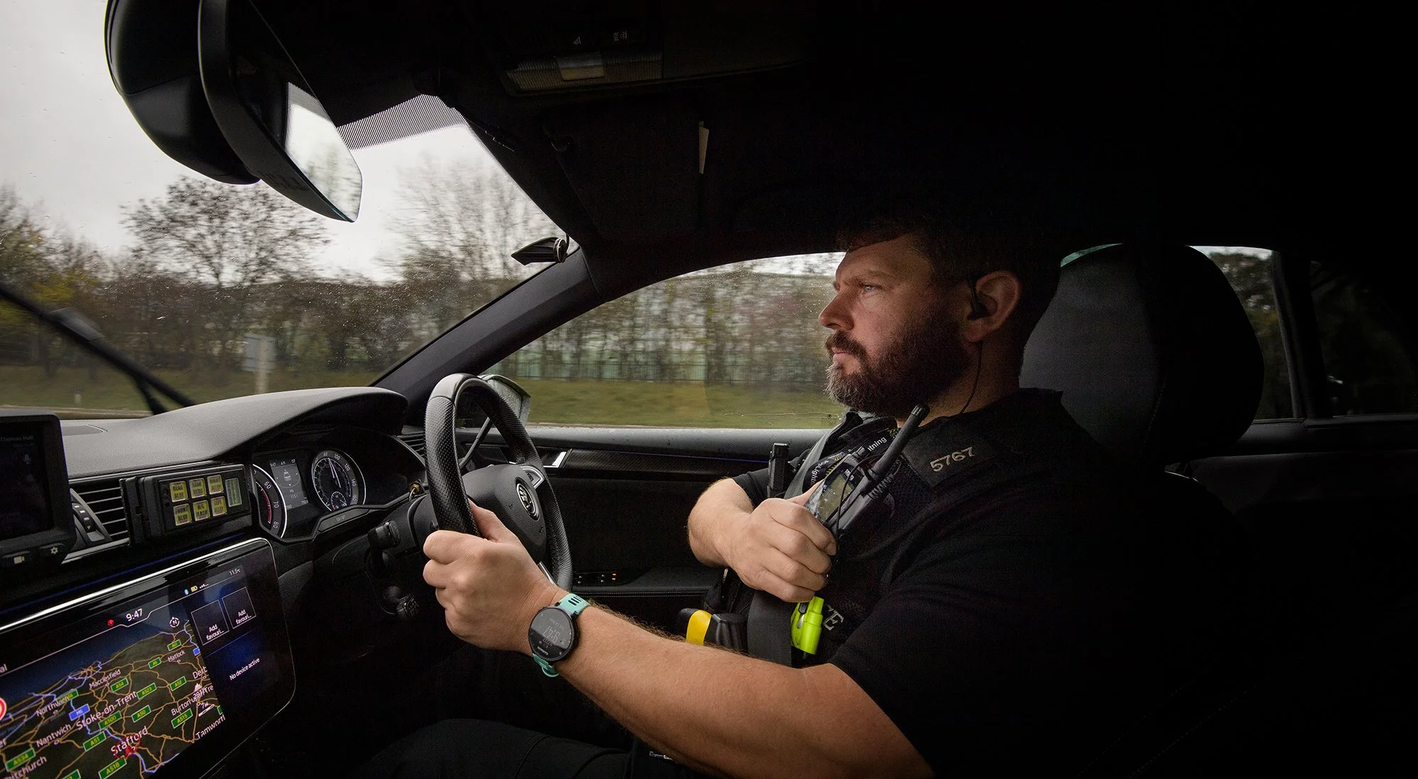 Policeman driving police car.