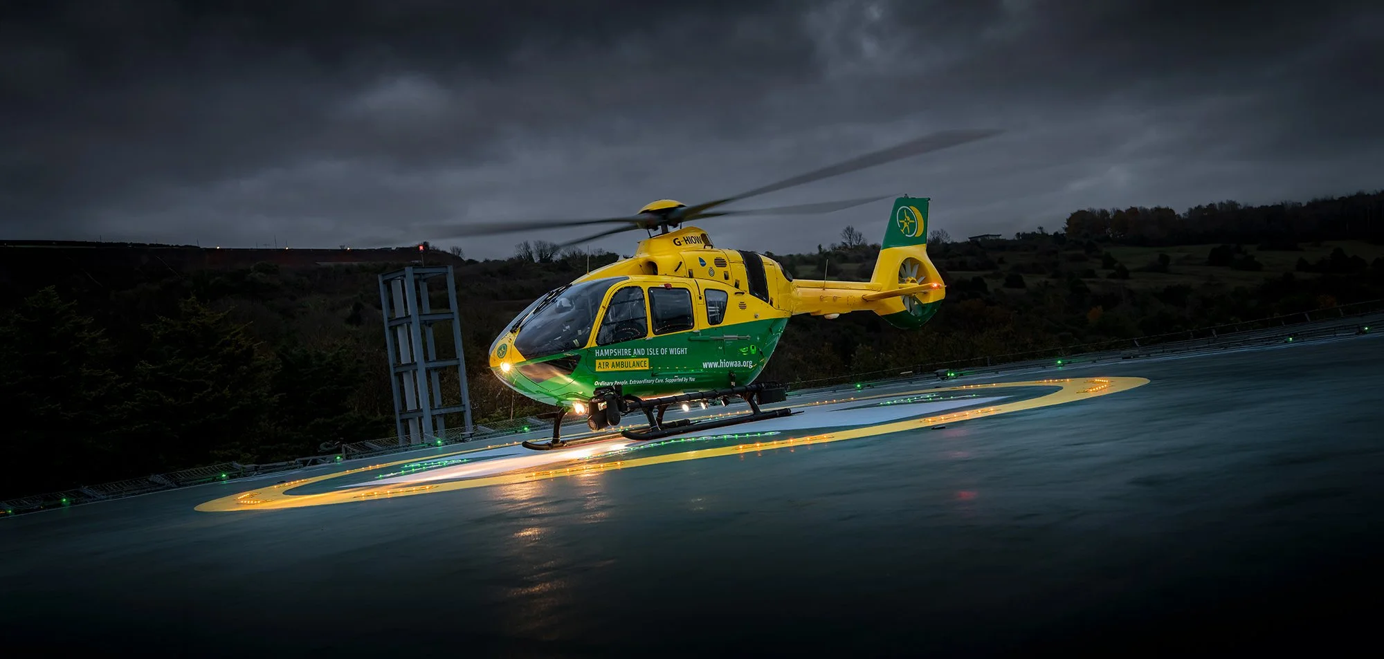Air Ambulance Helicopter on Hospital helipad at night.