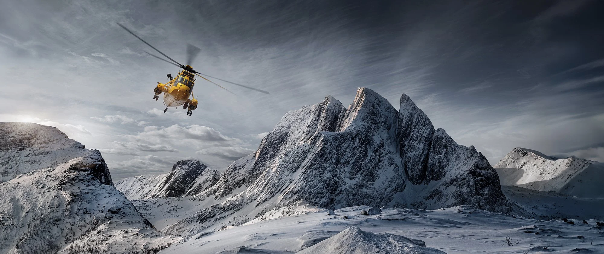 Westland Sea King HAR3 flying over snow covred mountains.