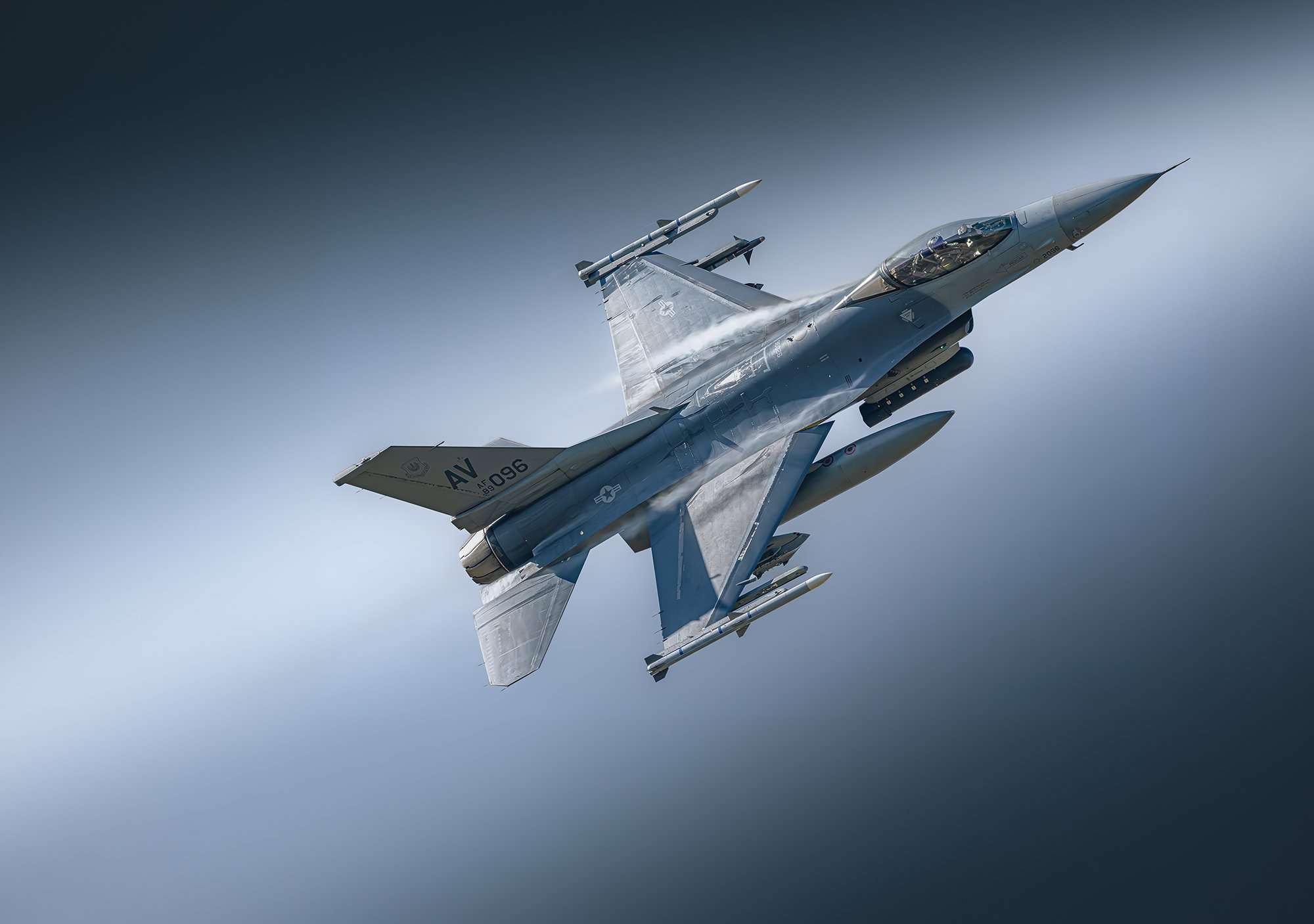 fighter jet climbing in sky