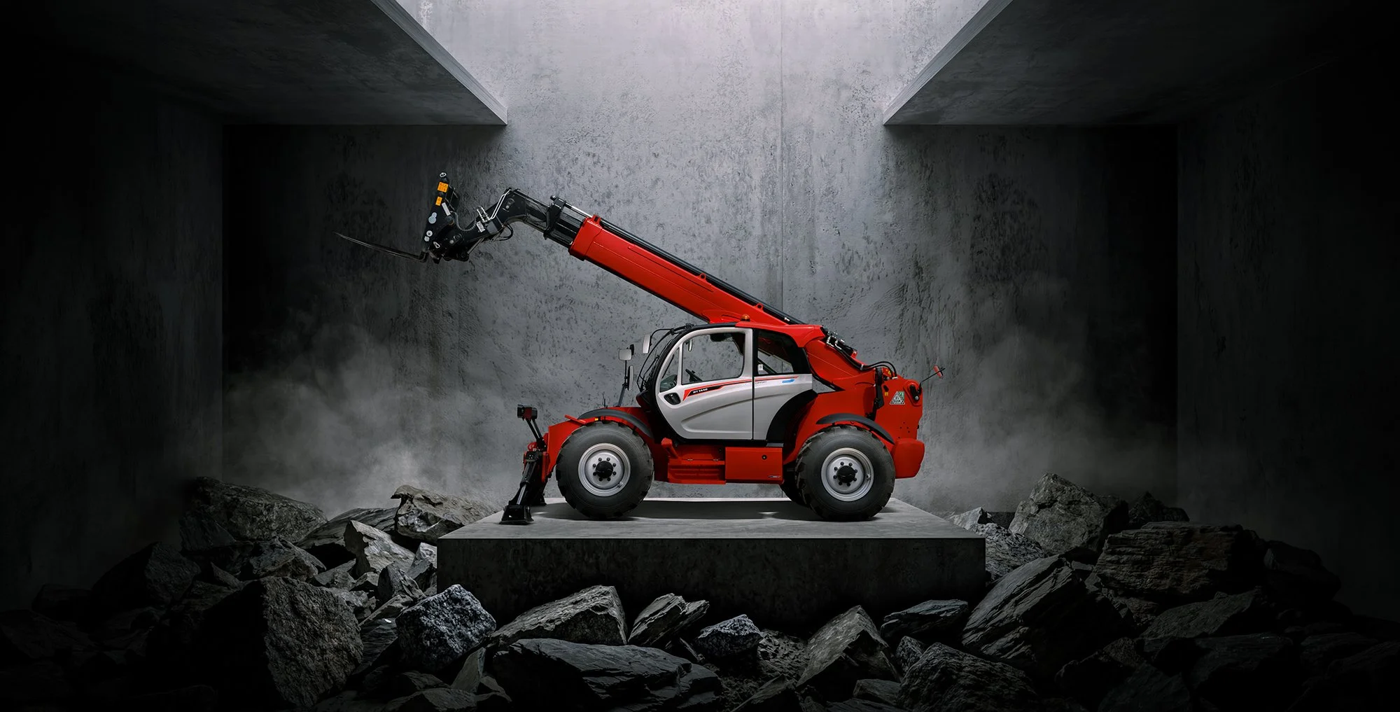 Telehandler in concrete background with rocks.