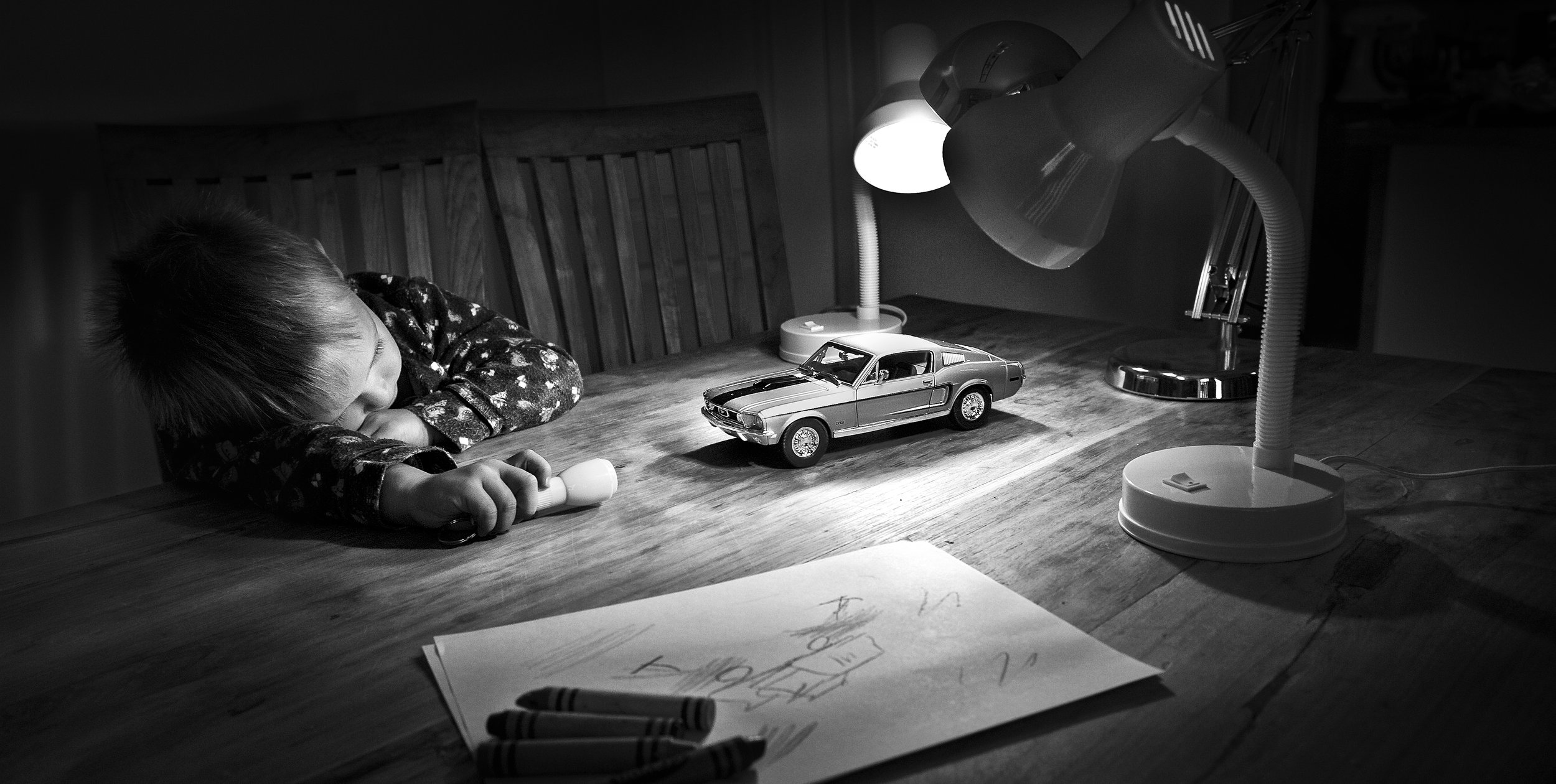 a young child lighting a car for photography