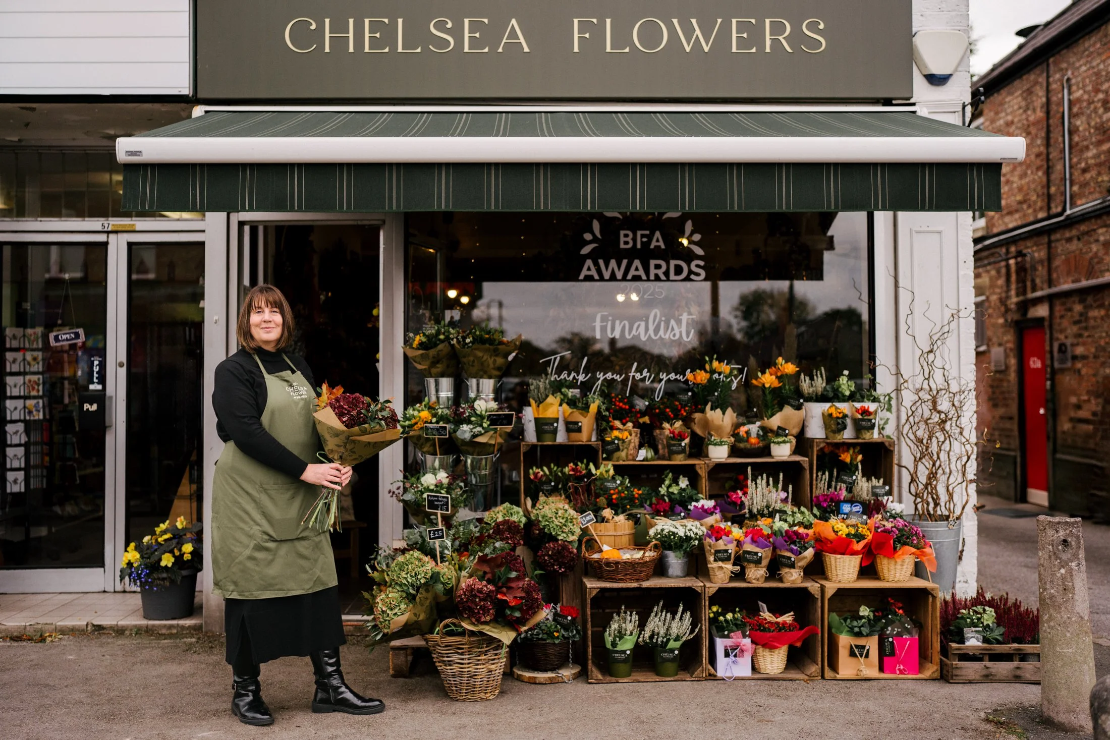A photograph of a store owner in Manchester for American Express. 