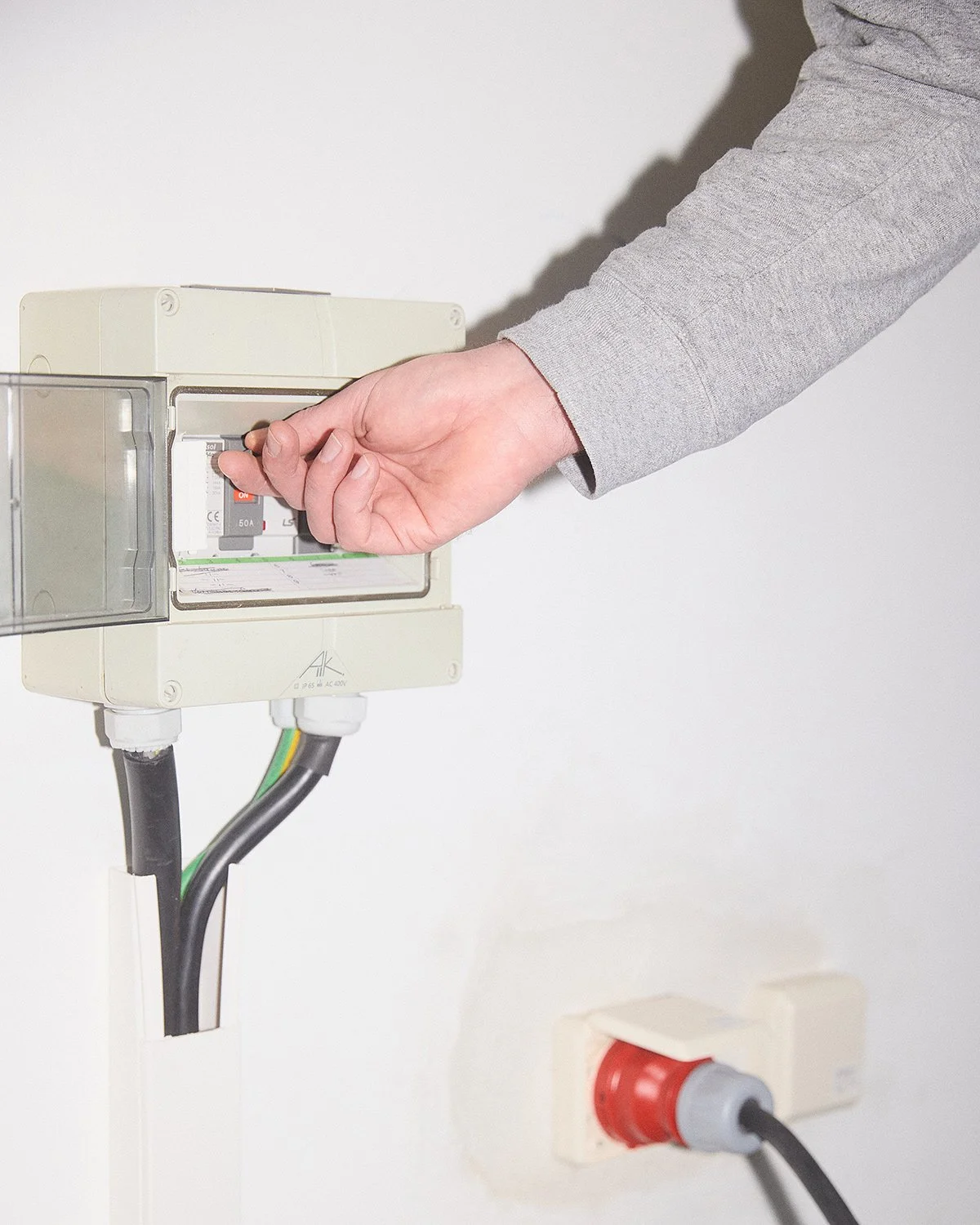 hand about to turn on a switch 