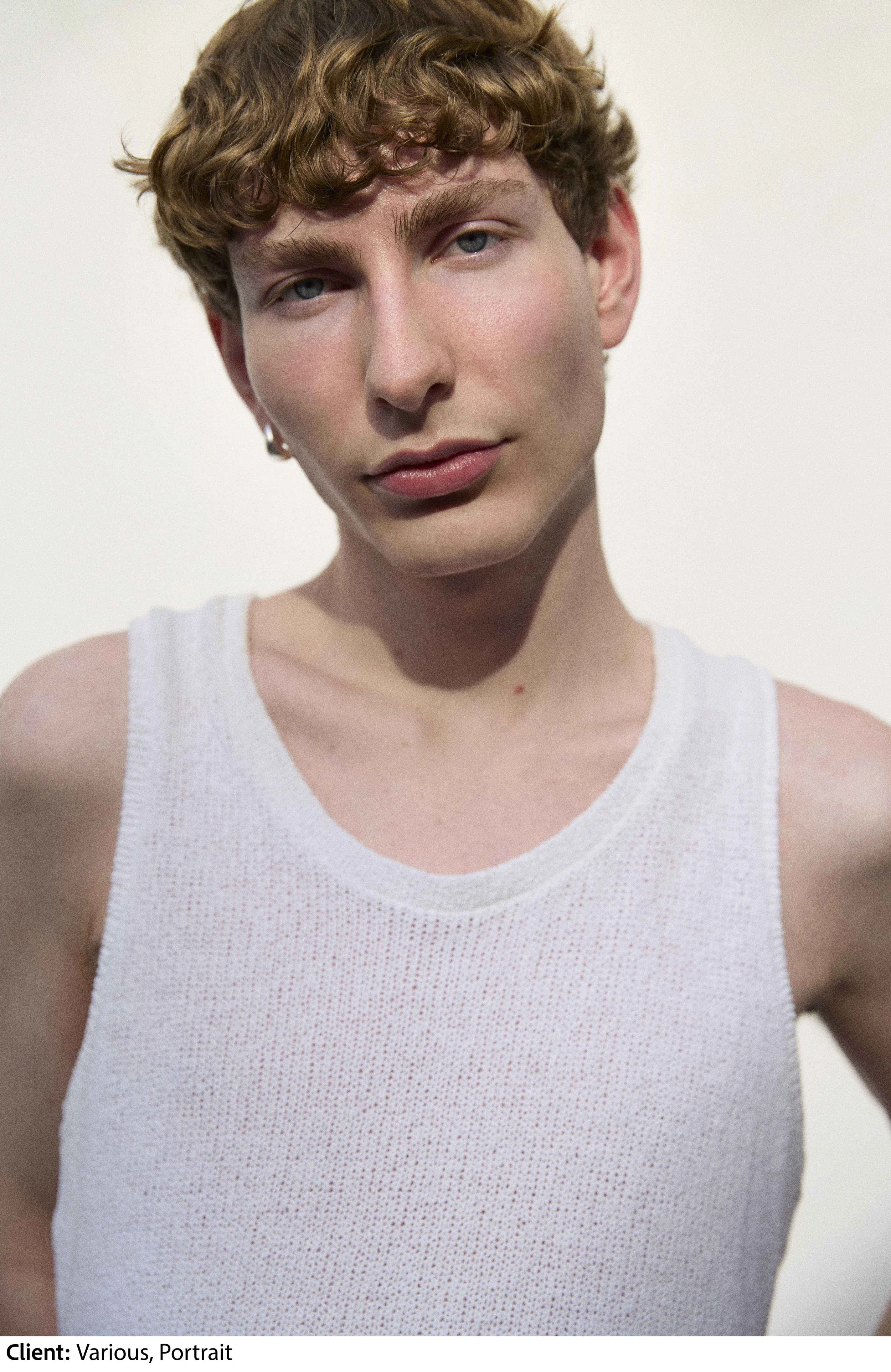 Tereza Konarikova editorial portrait of a young male model on light grey background with daylight