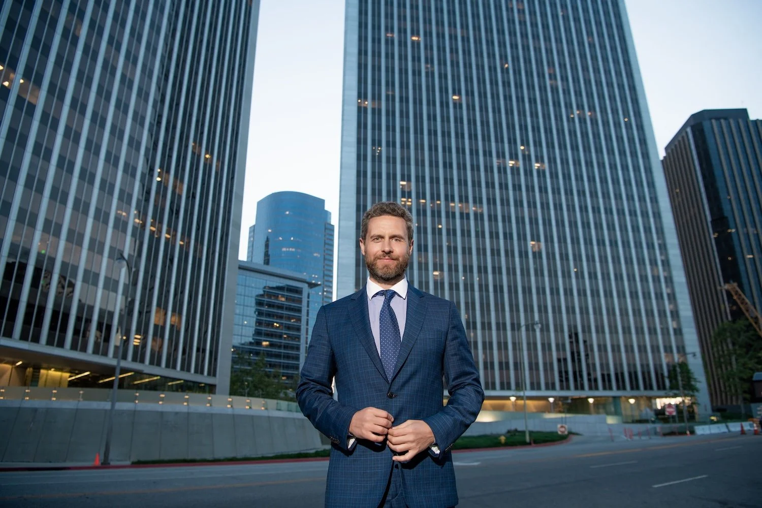 Owner of Multiple Businesses in front of tall office buildings