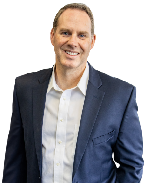 Jason Ballard - A smiling man with short hair, wearing a dark blue suit jacket and a white dress shirt, facing the camera.