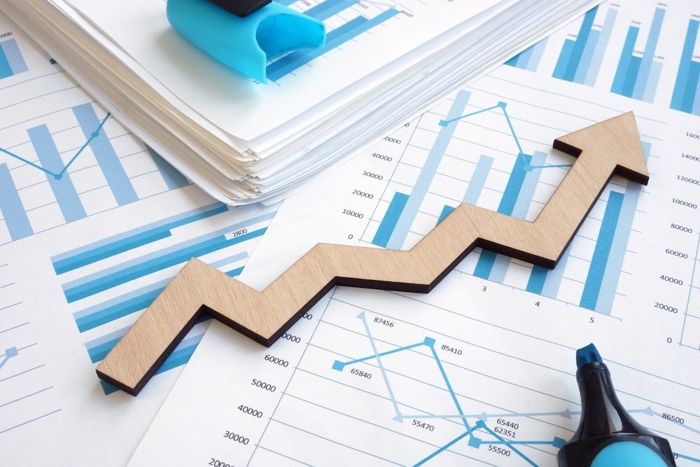 analytics charts with an upward moving arrow