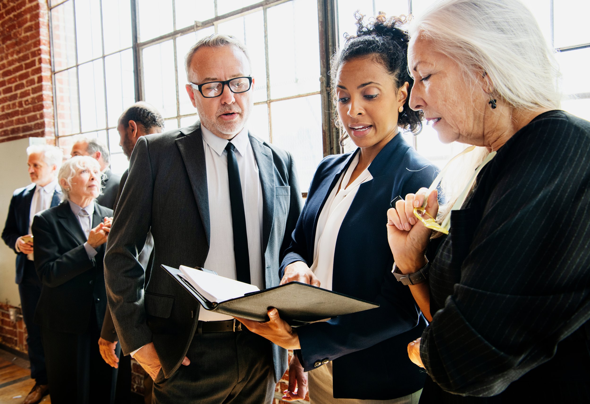 A group of high-level executives in business attire reviewing a strategic growth review plan
