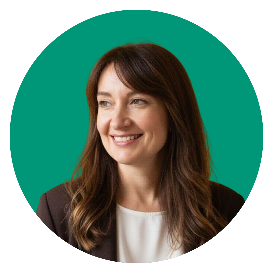 Headshot of a woman with long brown hair, smiling, wearing a black blazer and white top, against a green background.