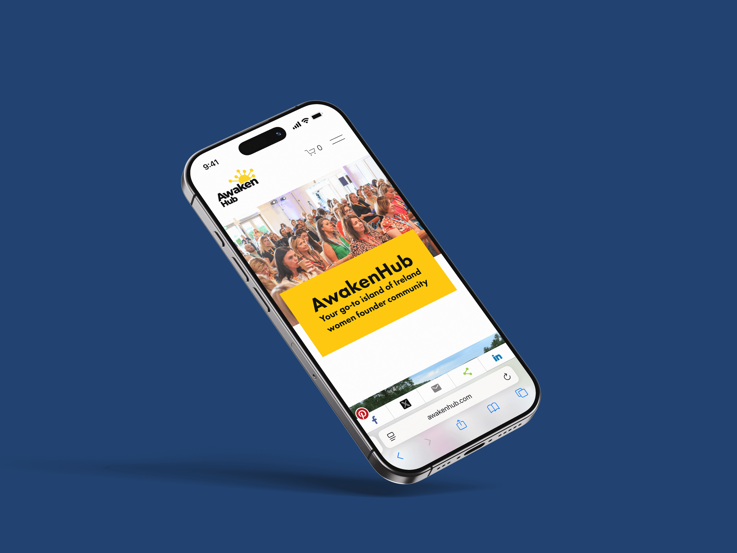Smartphone displaying the Awaken Hub website with an image of a group of women attending a conference and a yellow text box with the words "Awaken Hub, Your go-to island of Ireland women founder community".