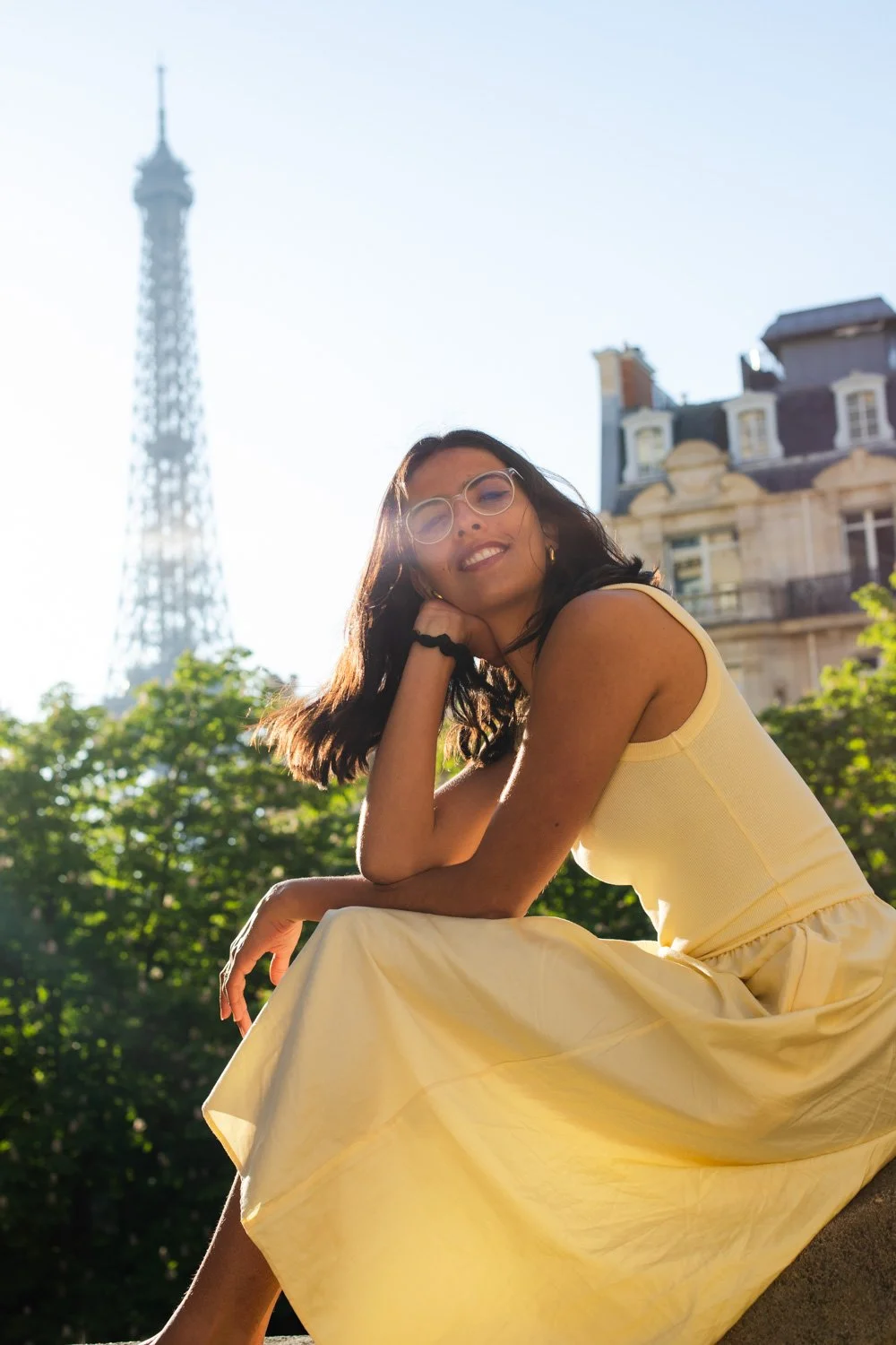 Girl poses by Eiffel Tower Paris