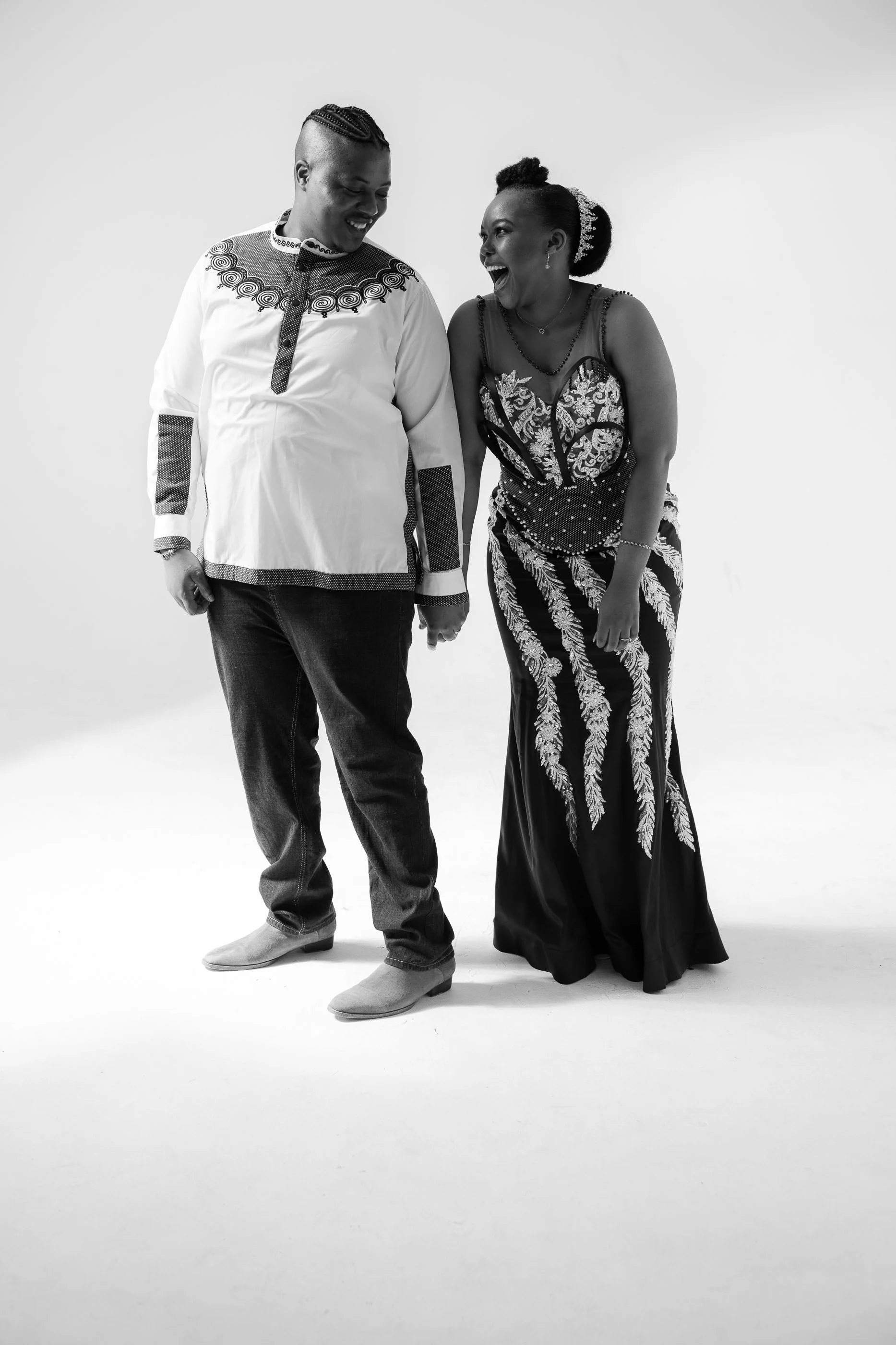 Couple holds hands and laughs