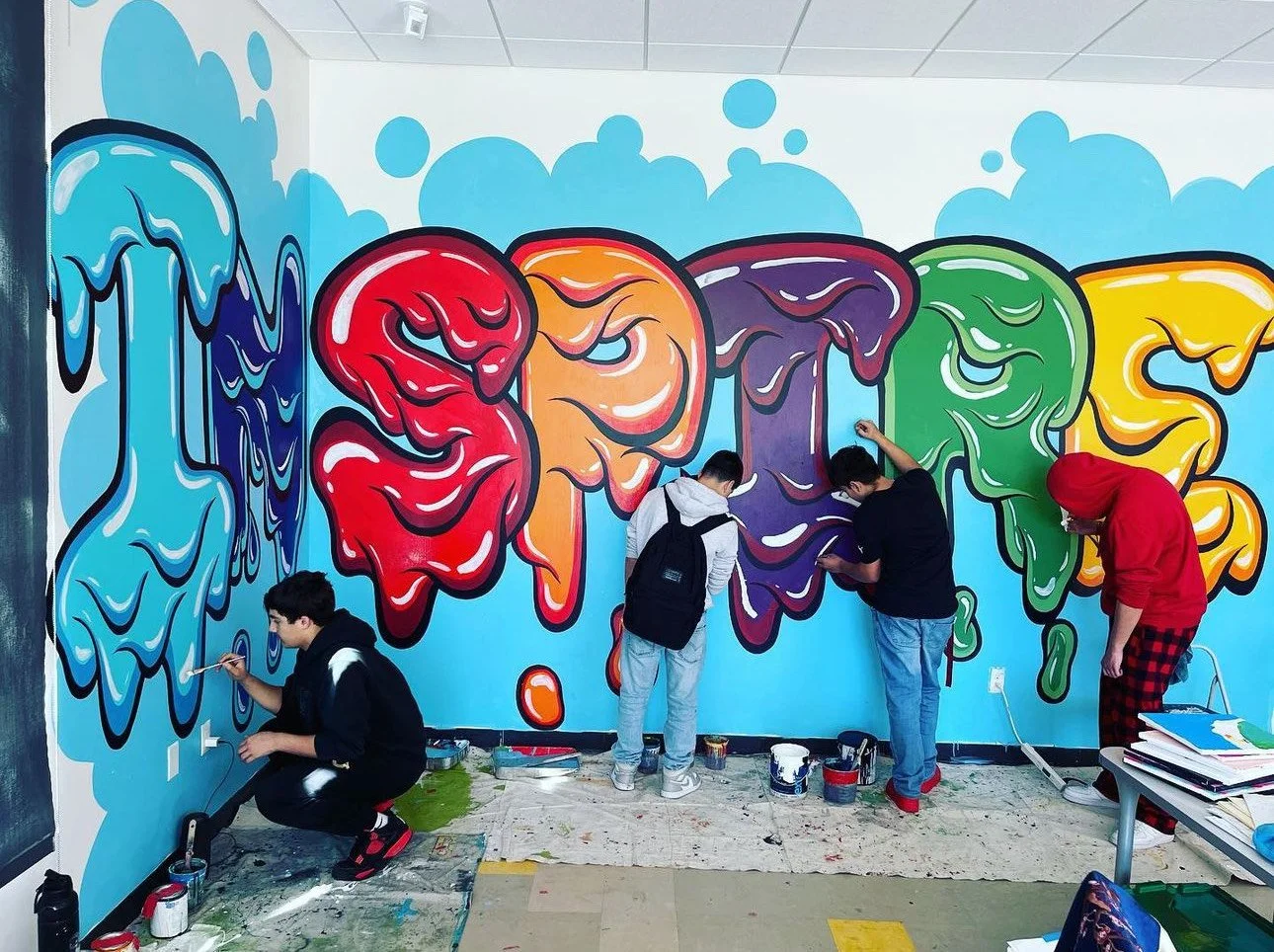 STUDENTS PAINTING MURALS