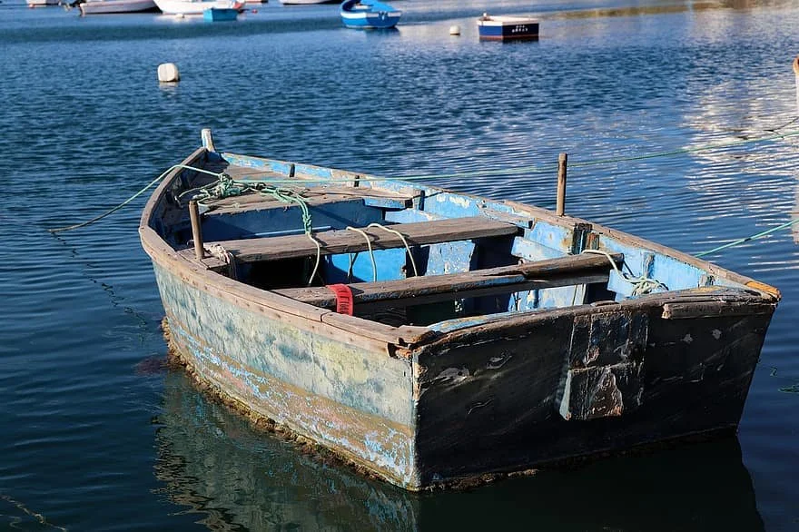 Rowboat on calm water, symbolizing the struggle of making progress in reflex integration when underlying issues like poor gut health create resistance.