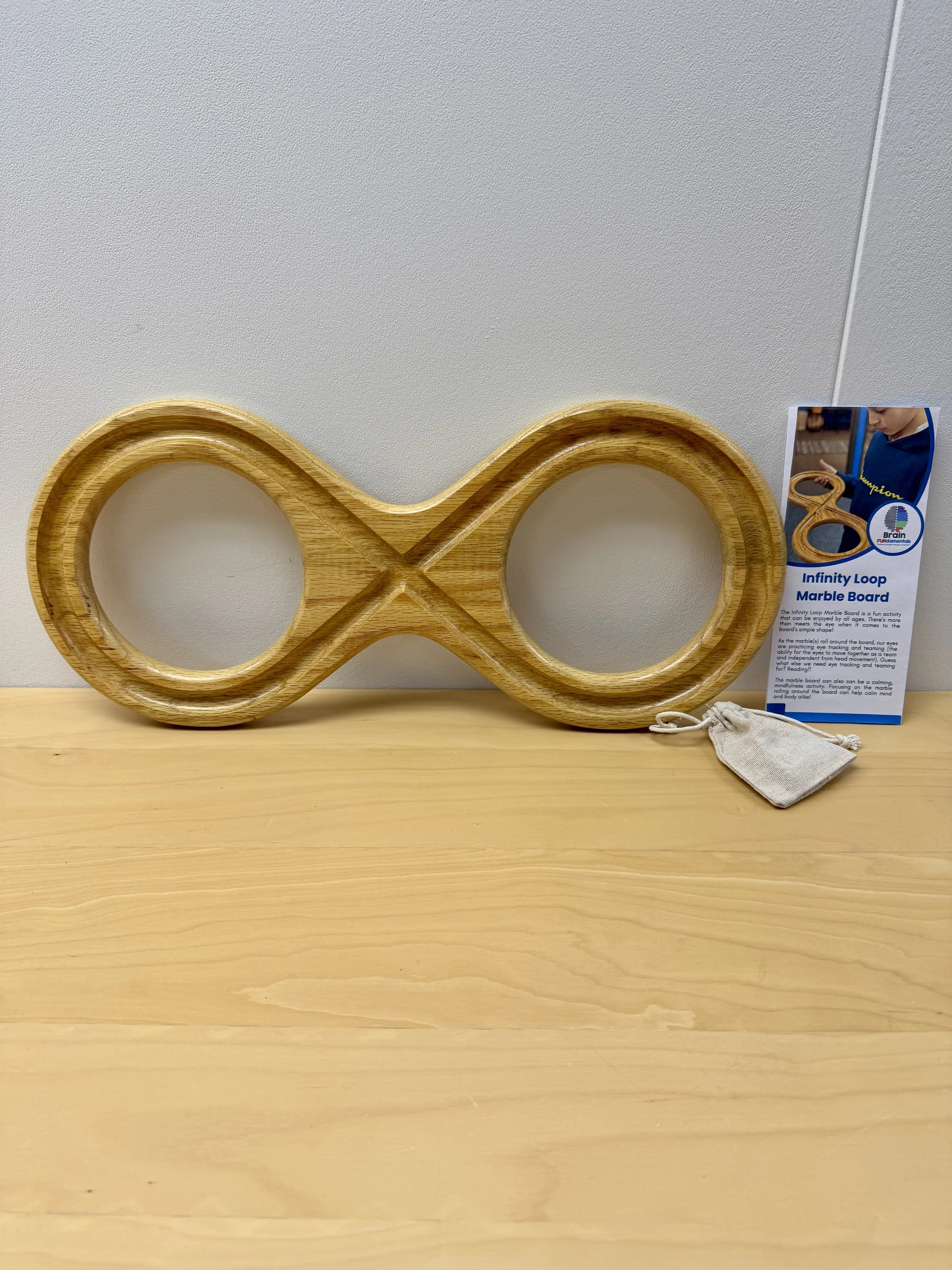 Wooden infinity marble board displayed on table with product tag