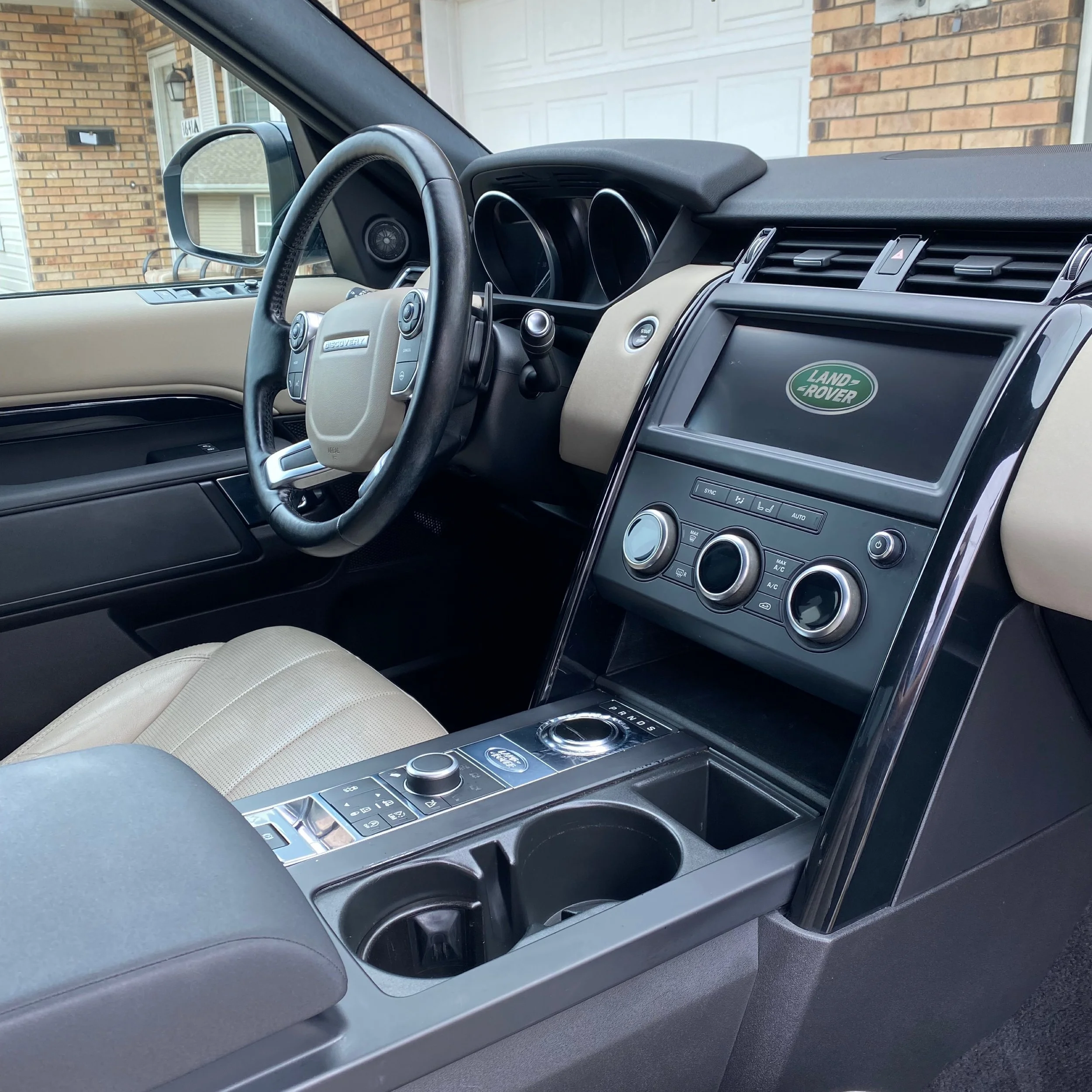 Interior of a Land Rover including the center console and the steering wheel