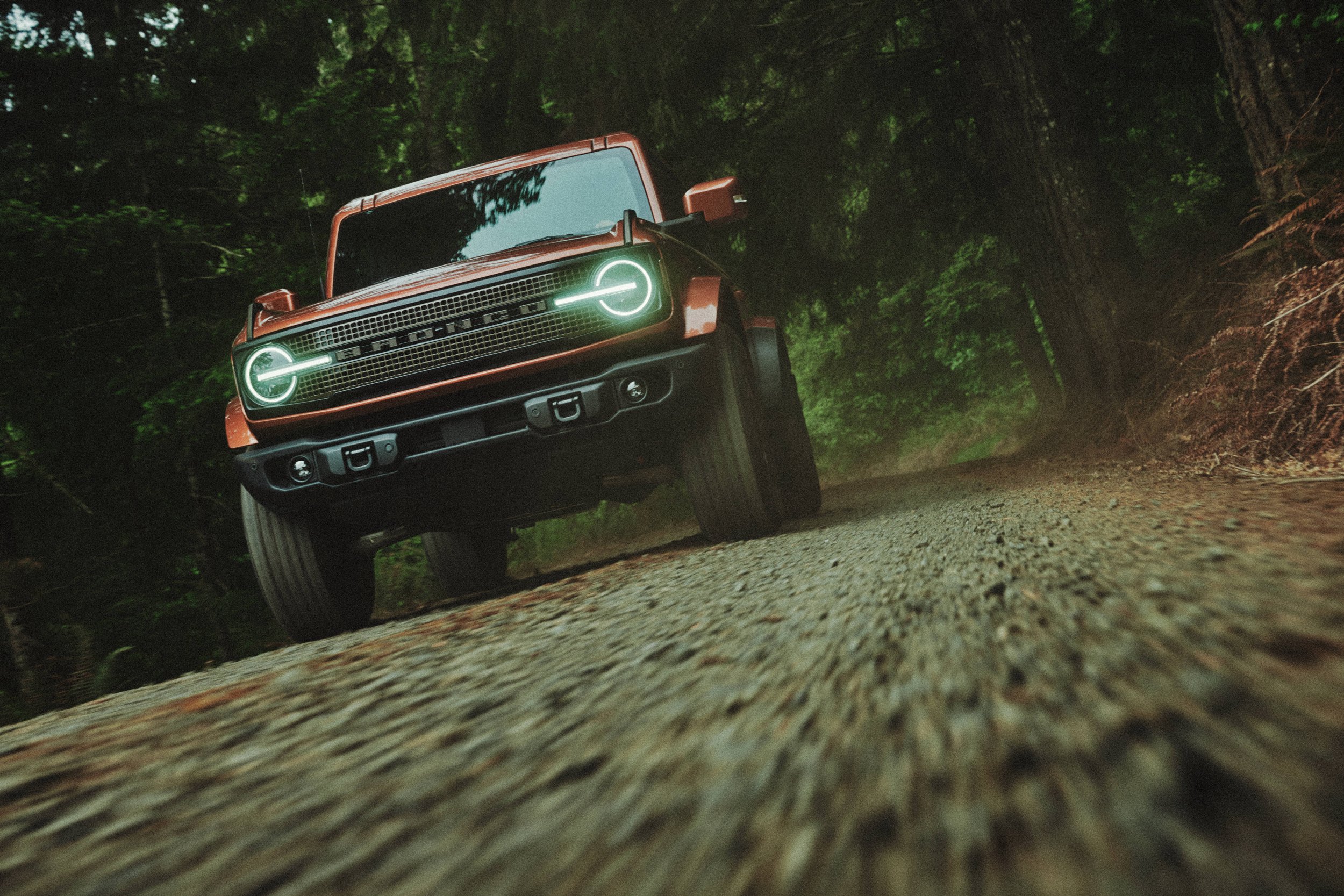 Front action shot of Bronco Filson First Edition driving on gravel road