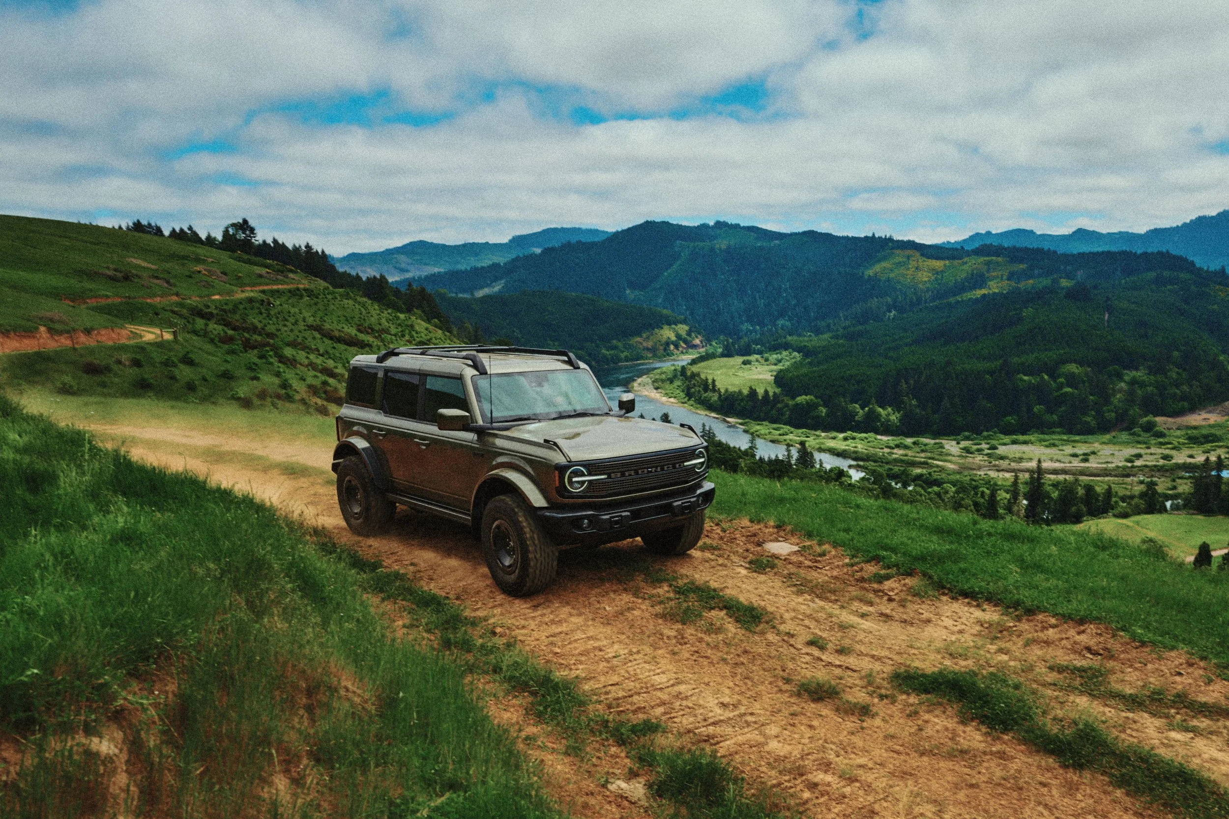 Bronco Filson driving on a dirt trail on the hillside