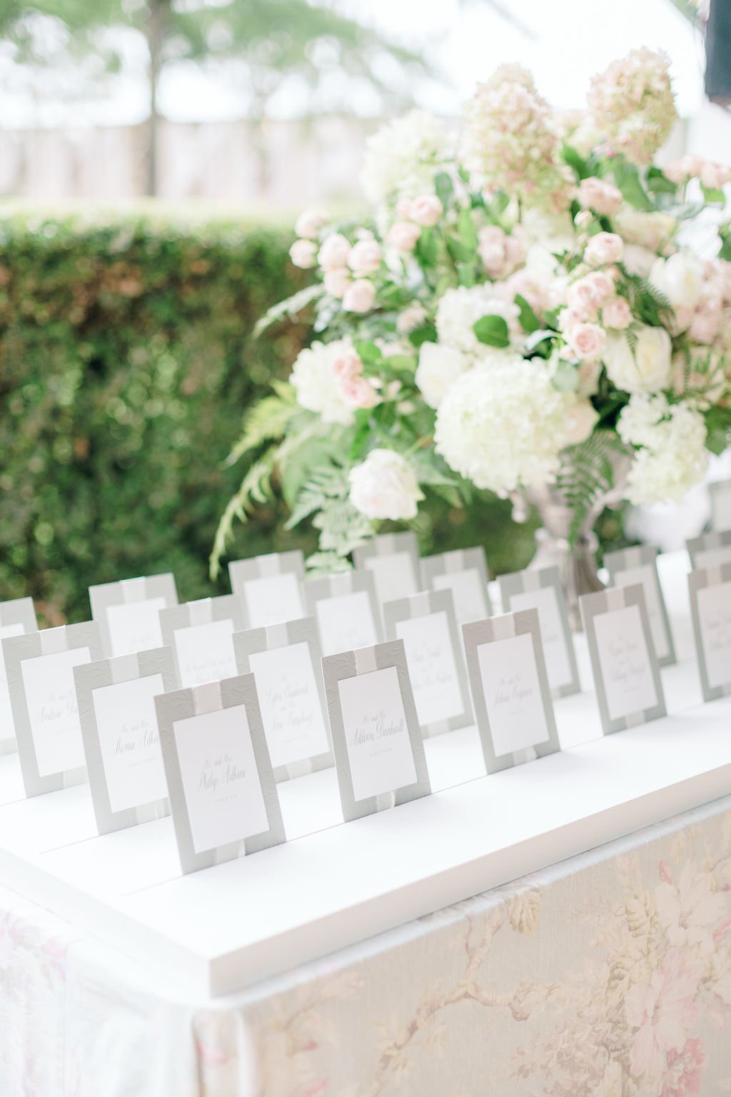 An elegant display of wedding escort cards surrounded by lush white and pink floral arrangements.
Clay Austin Photography
Blossoms Events
Technical Event Company (TEC)
Snyder Events
Charlottesville, Virginia
By George Press