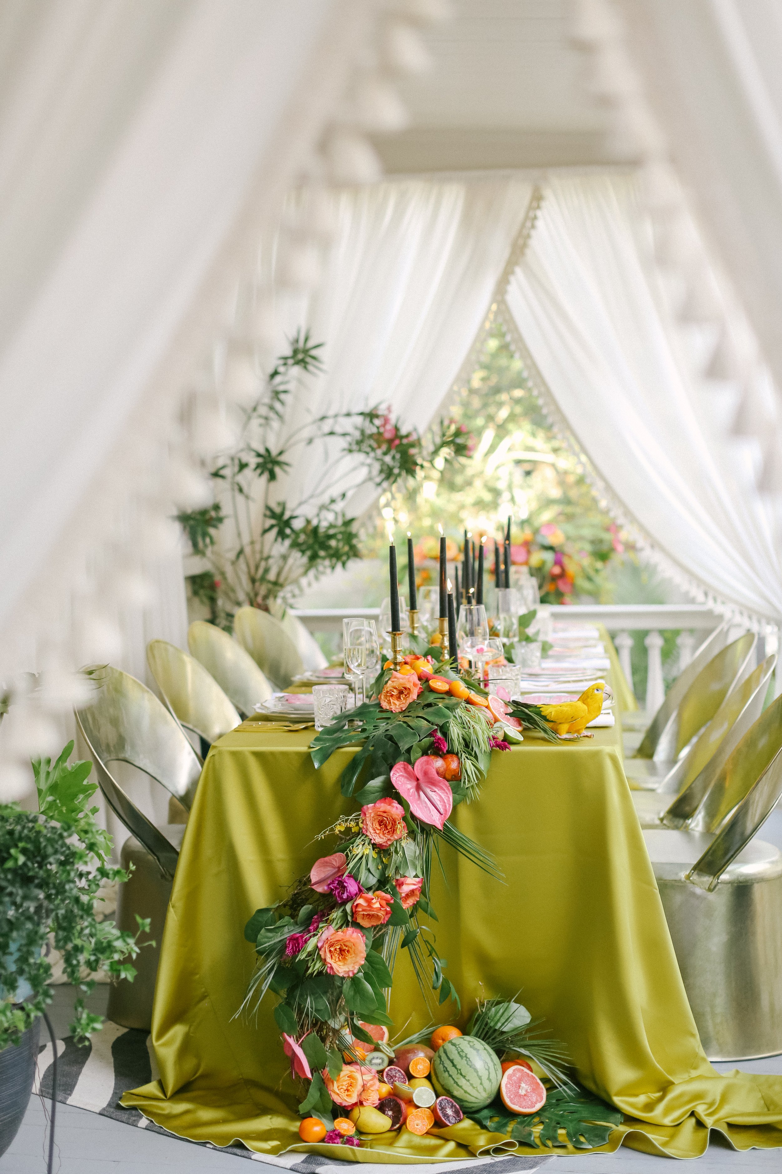 Tropical-inspired table decor with lush fruits and vibrant floral arrangements.
Julie Livingston Photography
Celadon
Snyder Events
Charleston, South Carolina