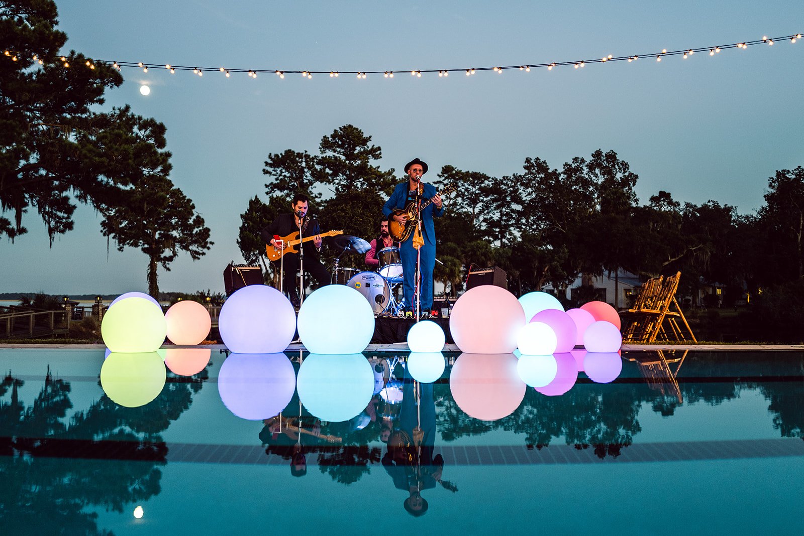 Live band performing by a poolside with glowing orb decorations reflecting in the water
Clark Brewer Photography
Technical Event Company (TEC)
Montage Palmetto Bluff
