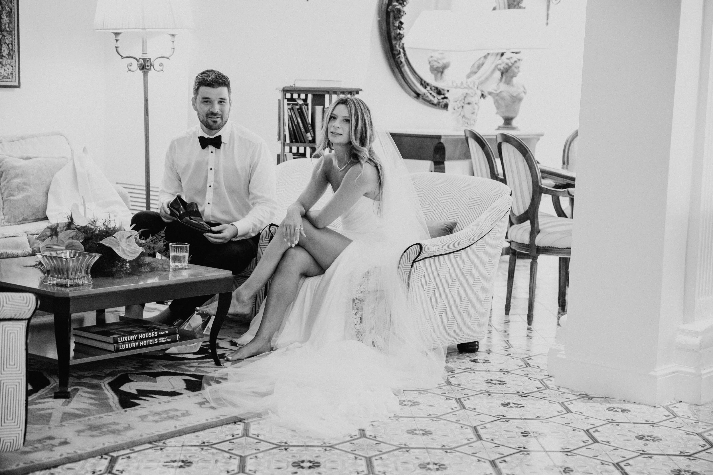 Bride and groom seated together indoors before their Italy destination wedding celebration.