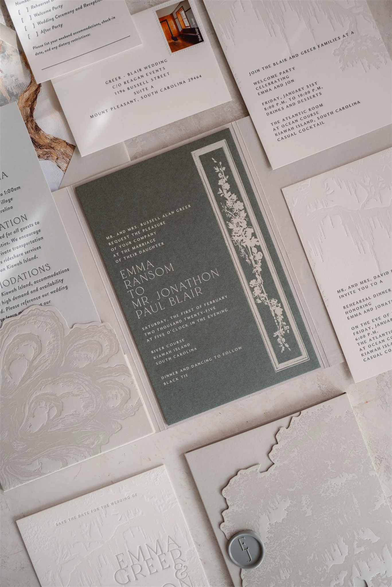 Textured gray and ivory wedding stationery suite for a Kiawah Island celebration, including invitation, rehearsal dinner card, RSVP pieces, and embossed details.