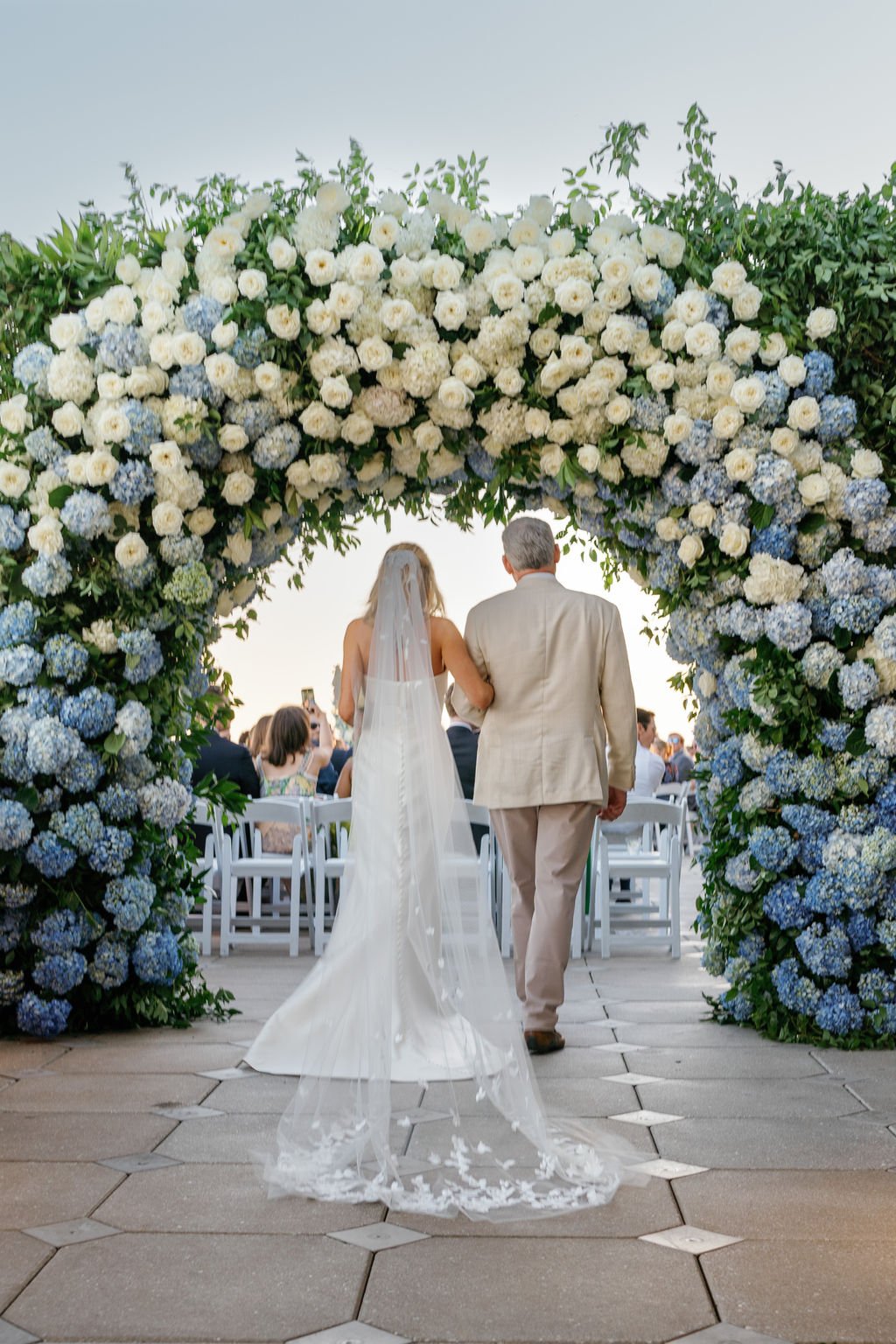 Stunning hydrangea archway frames the bride walking down the aisle in an outdoor wedding ceremony.
Abby Jiu Photography
Blossoms Events
Wild Dunes Resort
Charleston, South Carolina