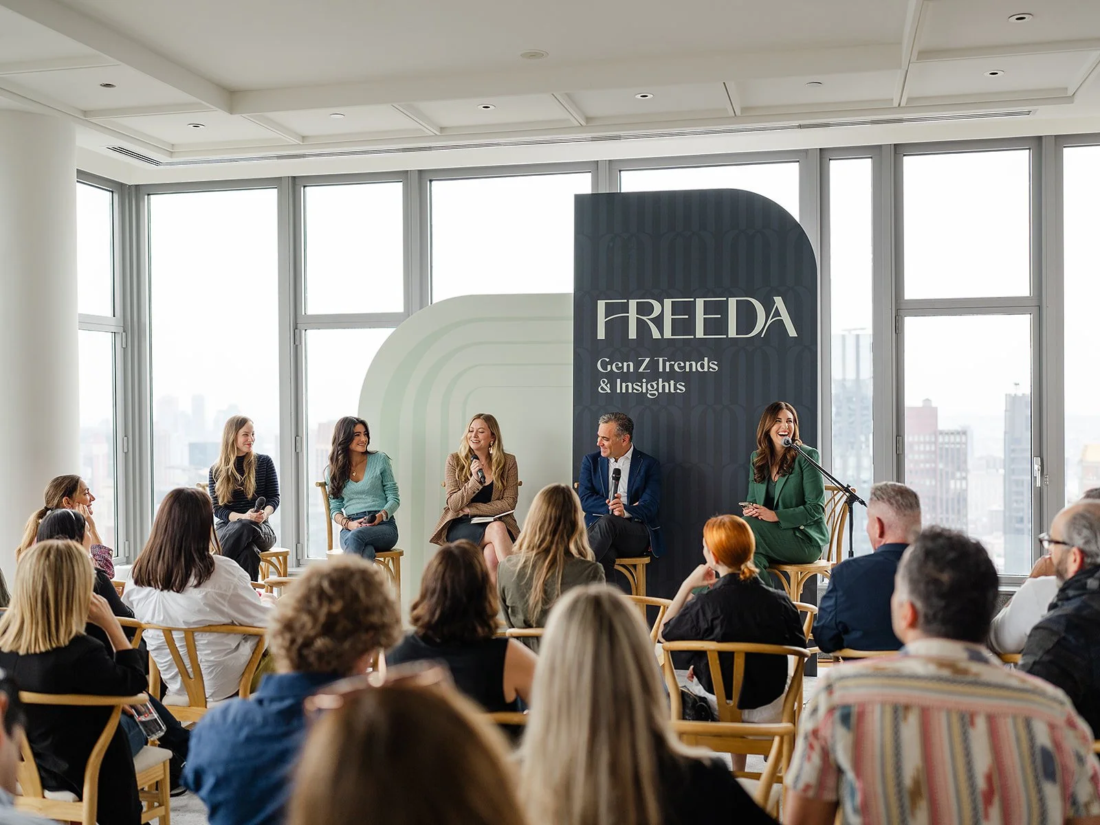 Panel discussion at a Freeda Network event with creative founders speaking in front of a branded Gen Z Trends and Insights backdrop.
