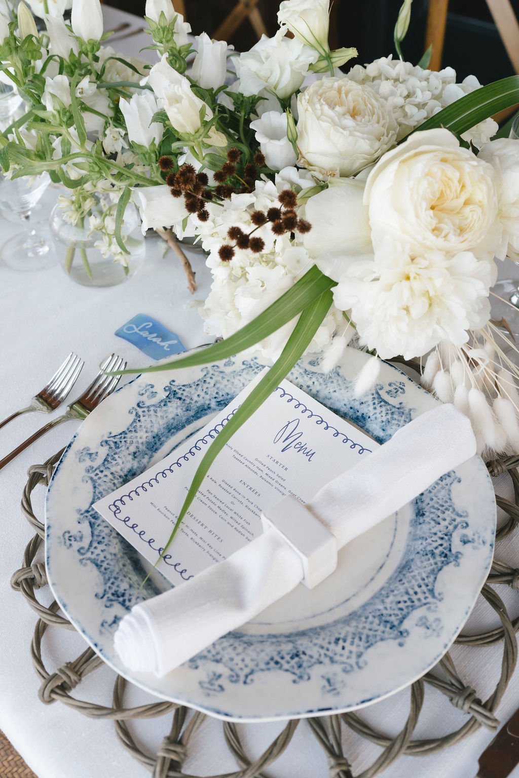 Sophisticated table setting with blue-patterned plates, white napkins, and lush floral centerpiece.
Gayle Brooker Photography
Blossoms Events
Snyder Events
Kiawah Island, South Carolina