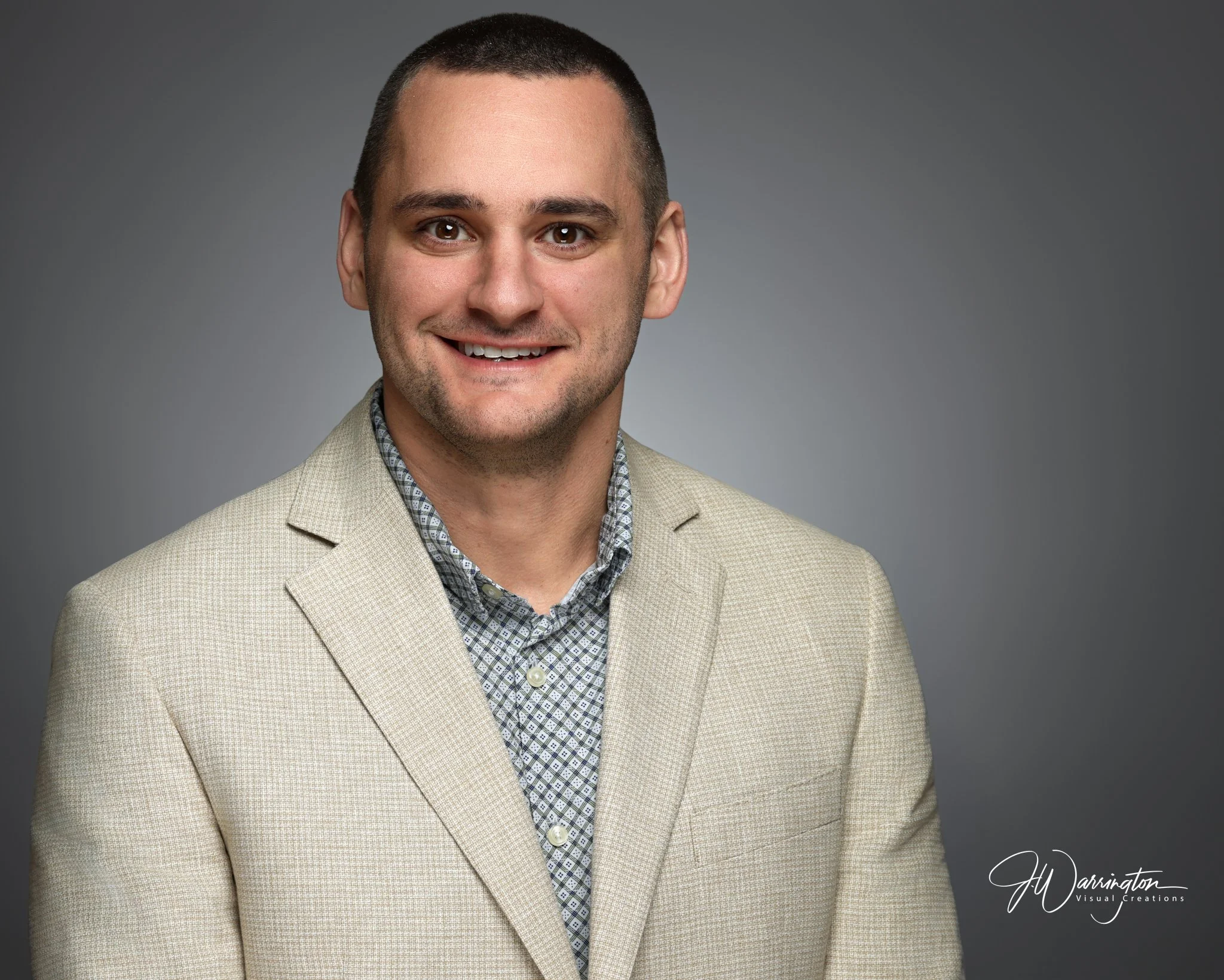 Young male professional wearing a cream suit jacket and floral button down headshot by findlay ohio photographer